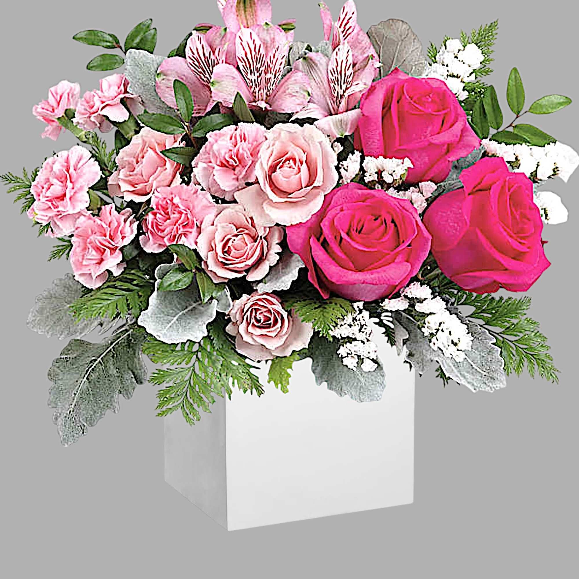 Pink roses and carnations in a white box with mixed greenery