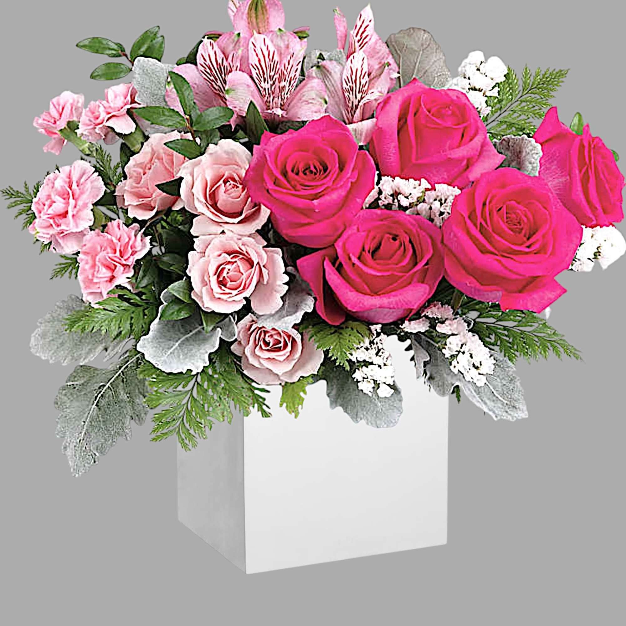 Pink roses and carnations arranged in a white box