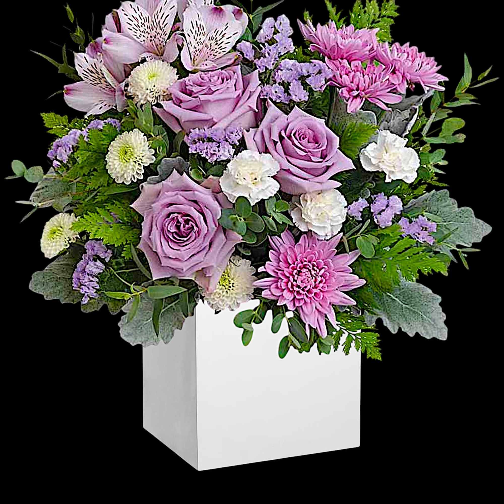 Lavender roses and pink chrysanthemums in a white square vase