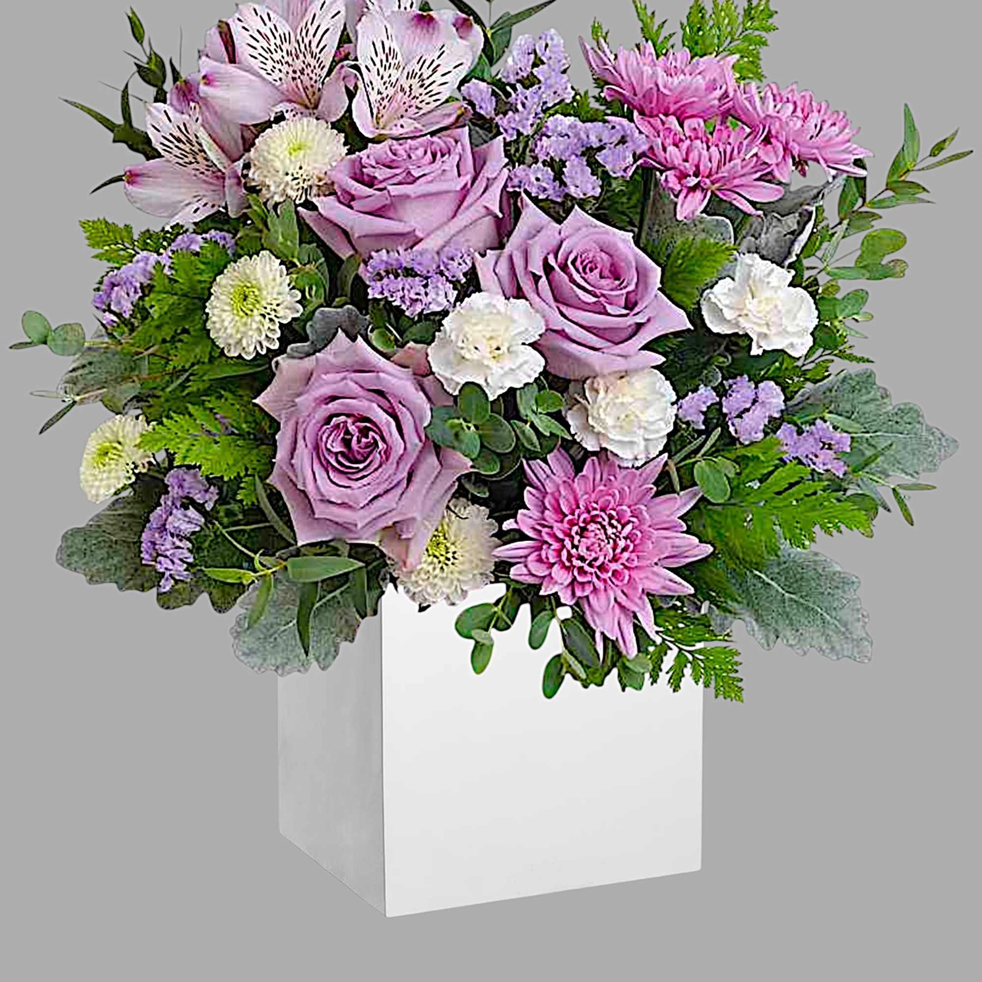 Lavender roses and pink chrysanthemums in a white box vase