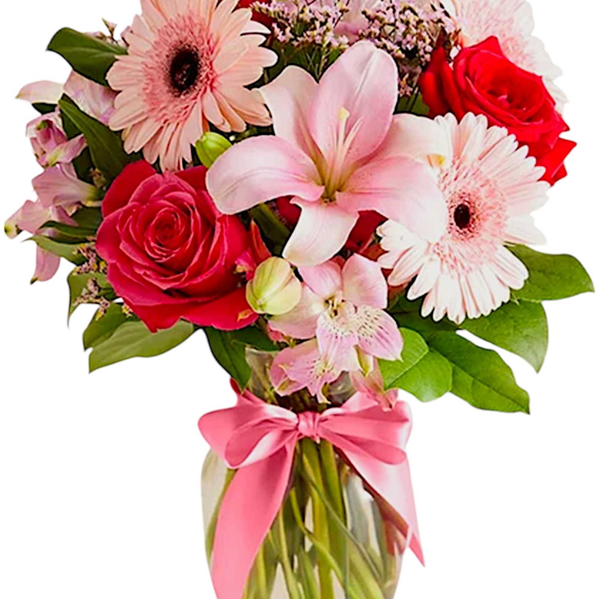 Bouquet of pink and red flowers in a glass vase with a pink ribbon