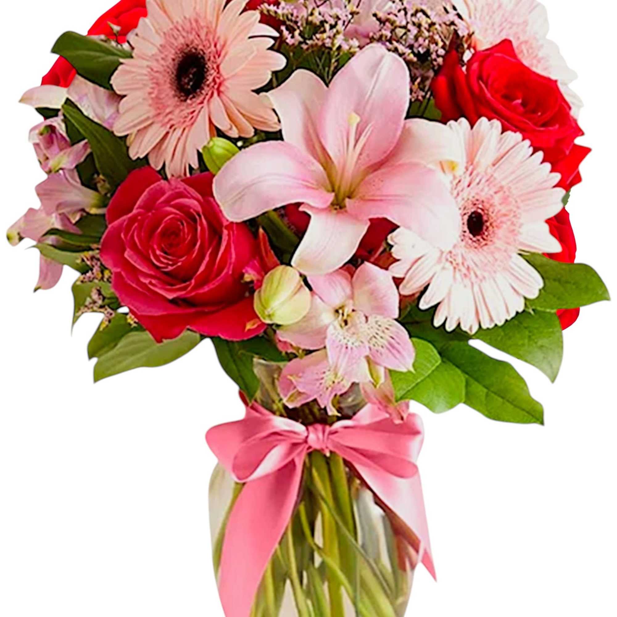 Bouquet of pink lilies, red roses, and pale gerbera daisies in a glass vase