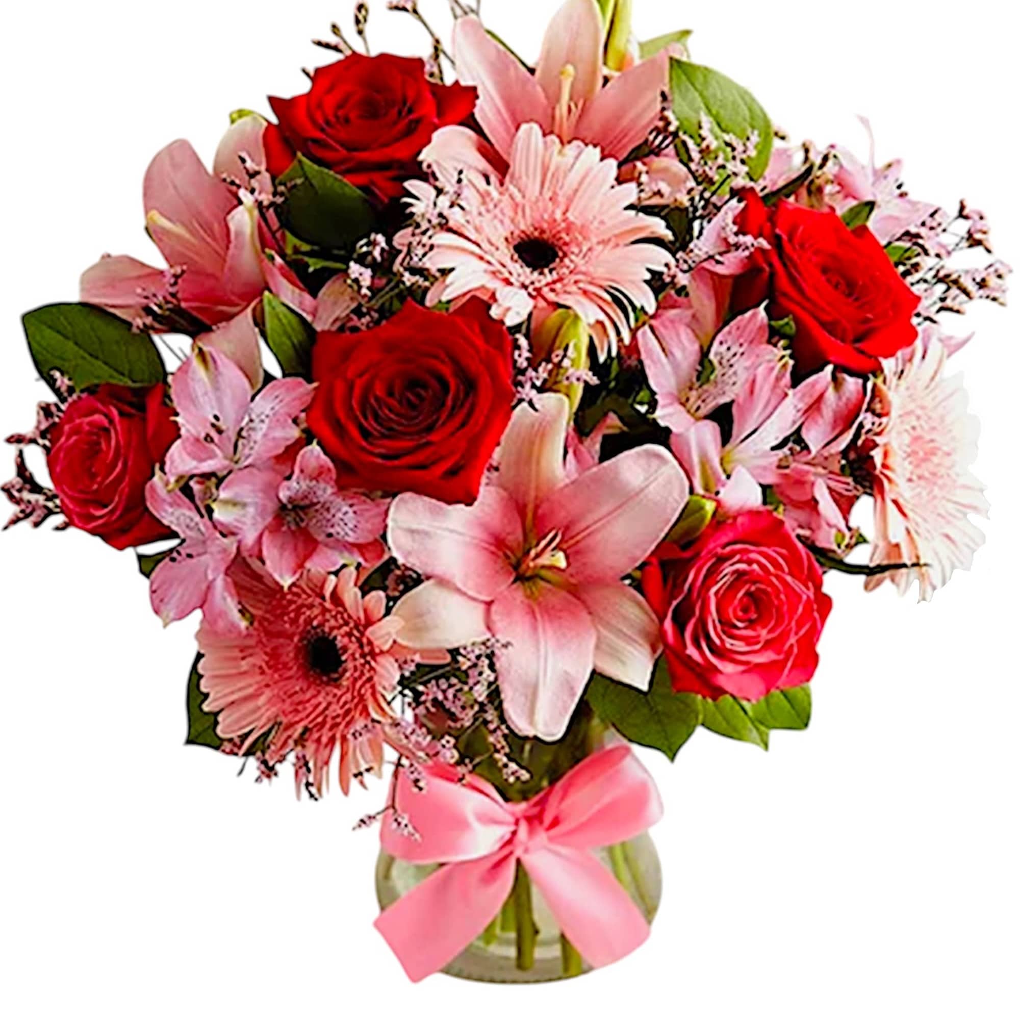 Bouquet of red roses and pink lilies in a glass vase with a pink ribbon