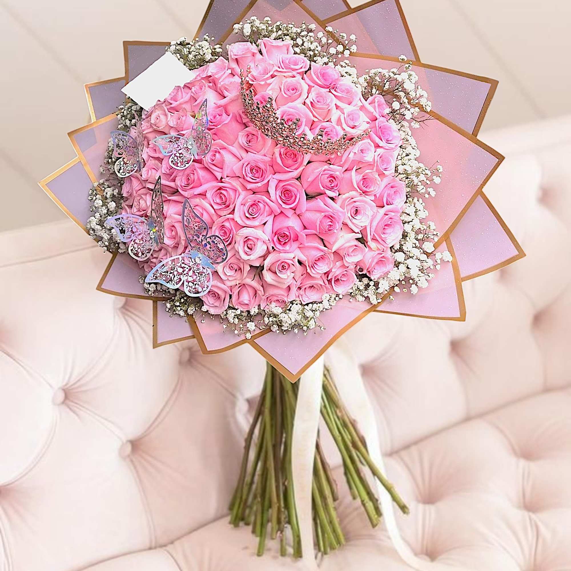 Pink rose bouquet with baby’s breath and butterfly decorations, photo 2 of 5