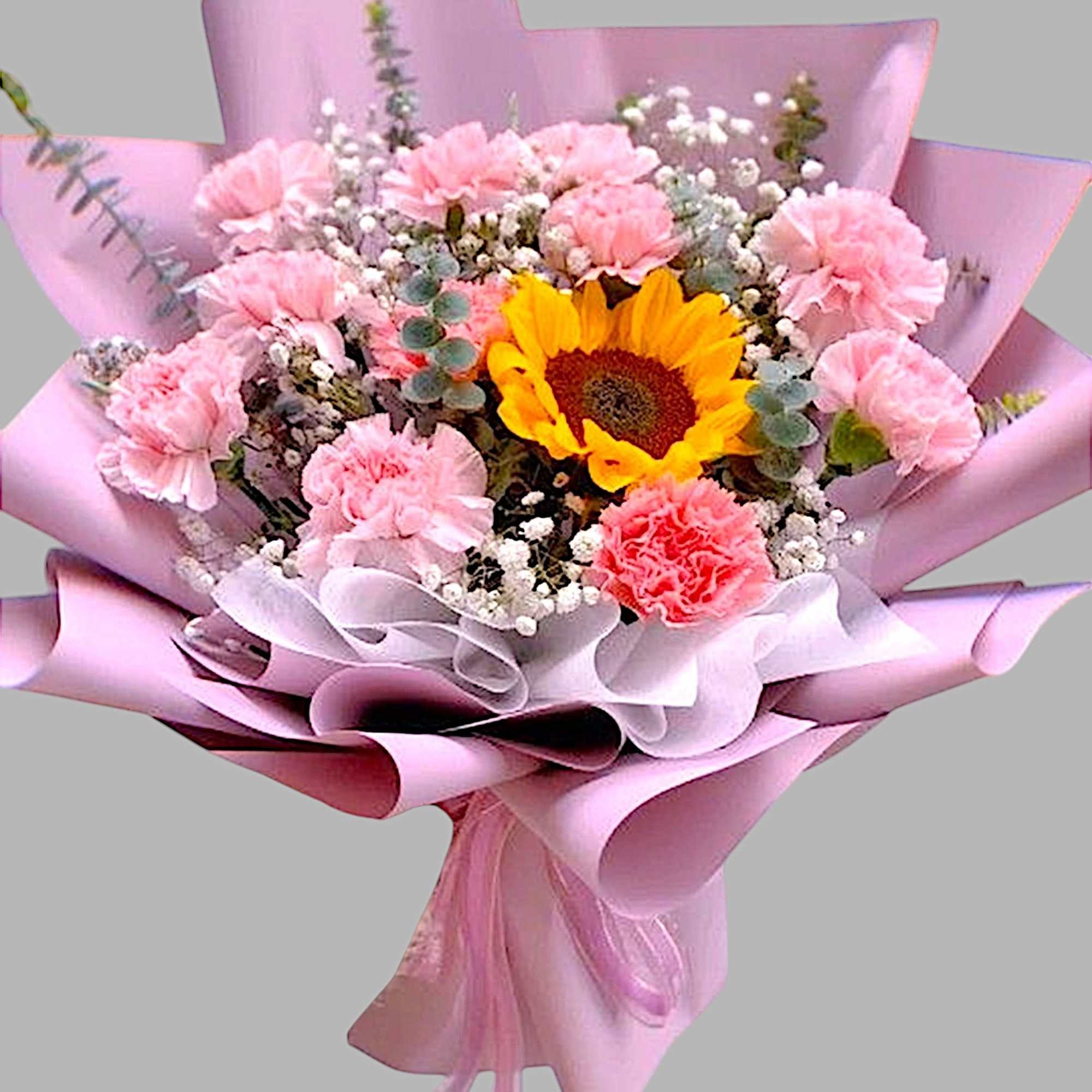 Pink bouquet with a sunflower and ribbon wrap