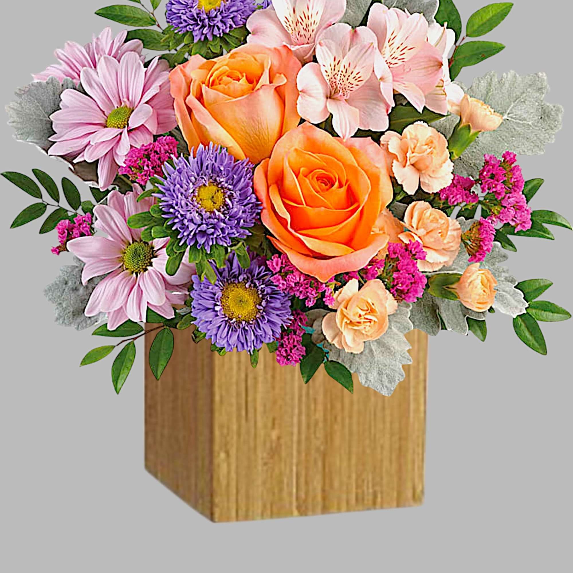 Mixed bouquet in a wooden box with orange roses and pink flowers