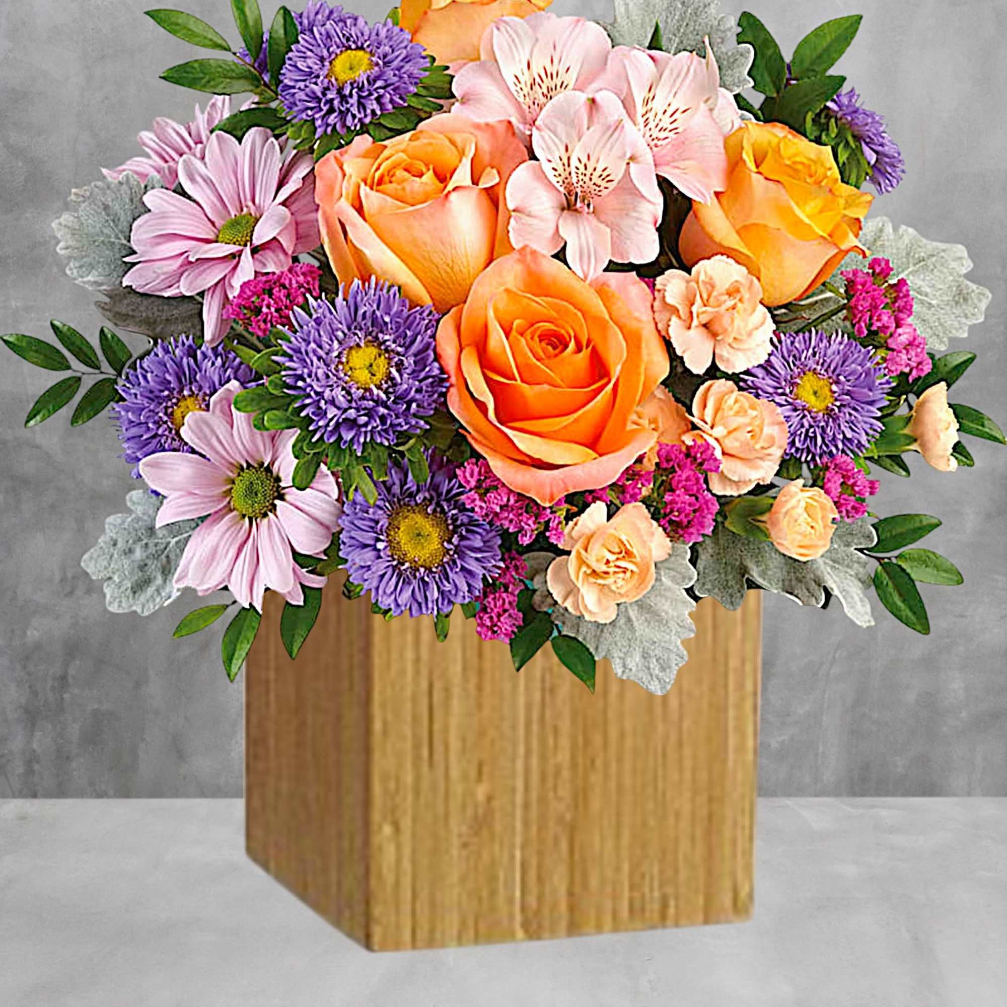 Everyone's abuzz about this beautiful arrangement! Lush orange roses and delicate pink