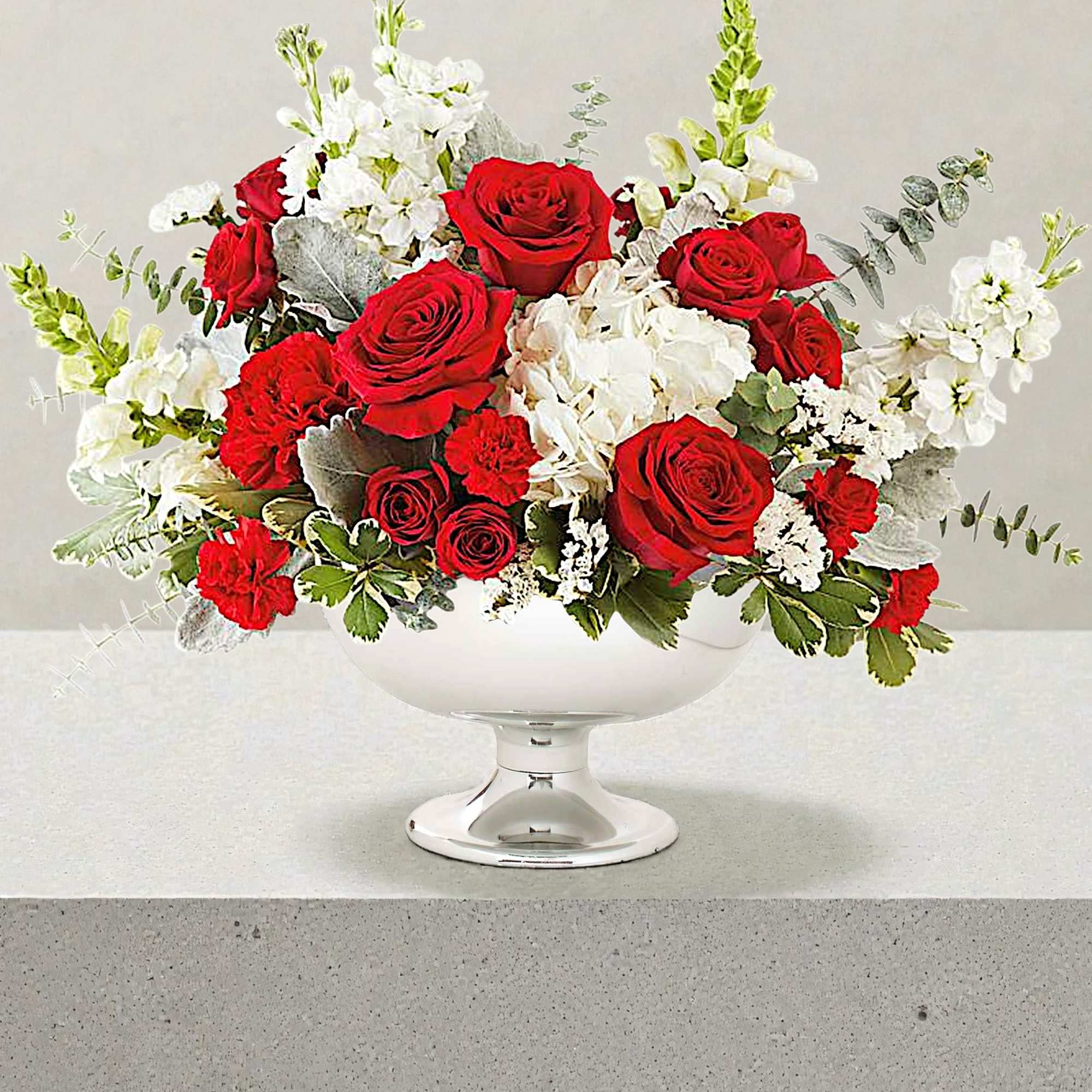 Red roses and white flowers arranged in a white pedestal vase, photo 2 of 4