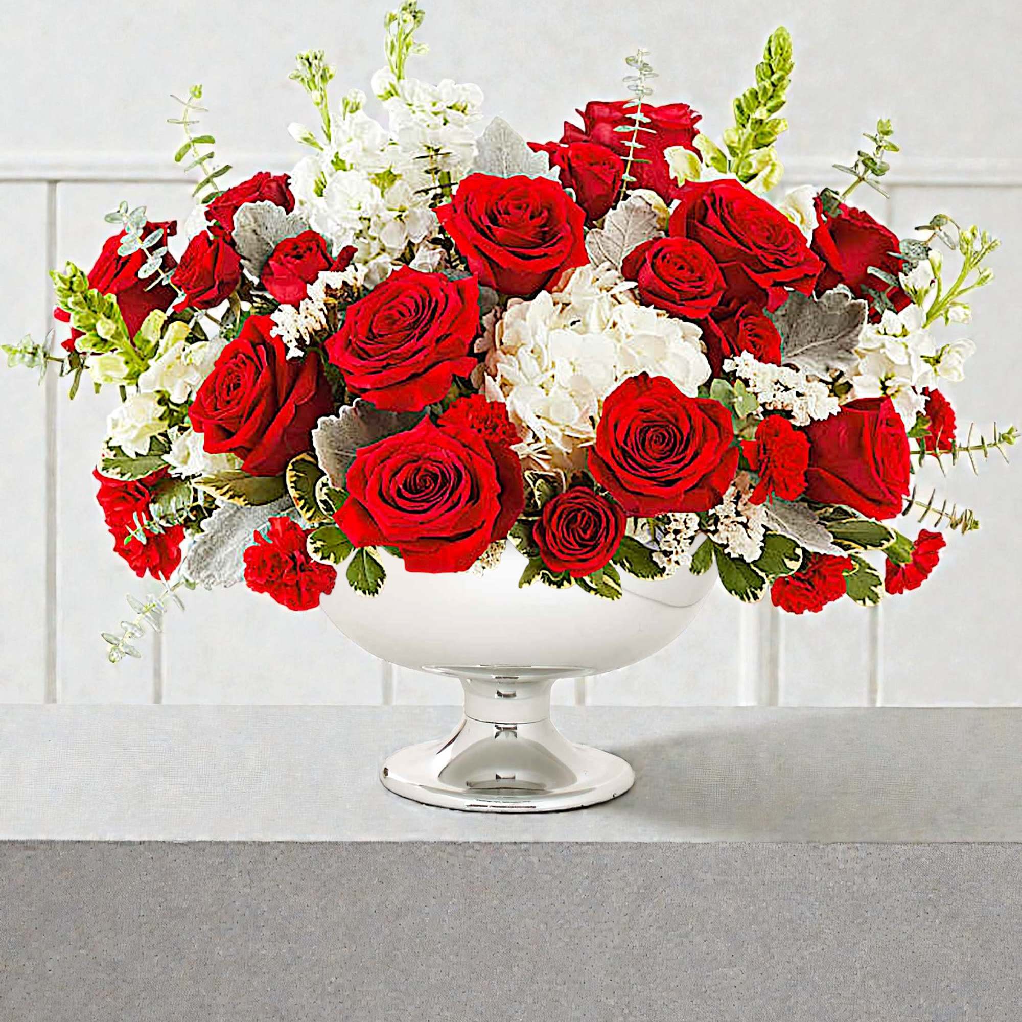 Red roses and white flowers arranged in a white pedestal vase, photo 2 of 4