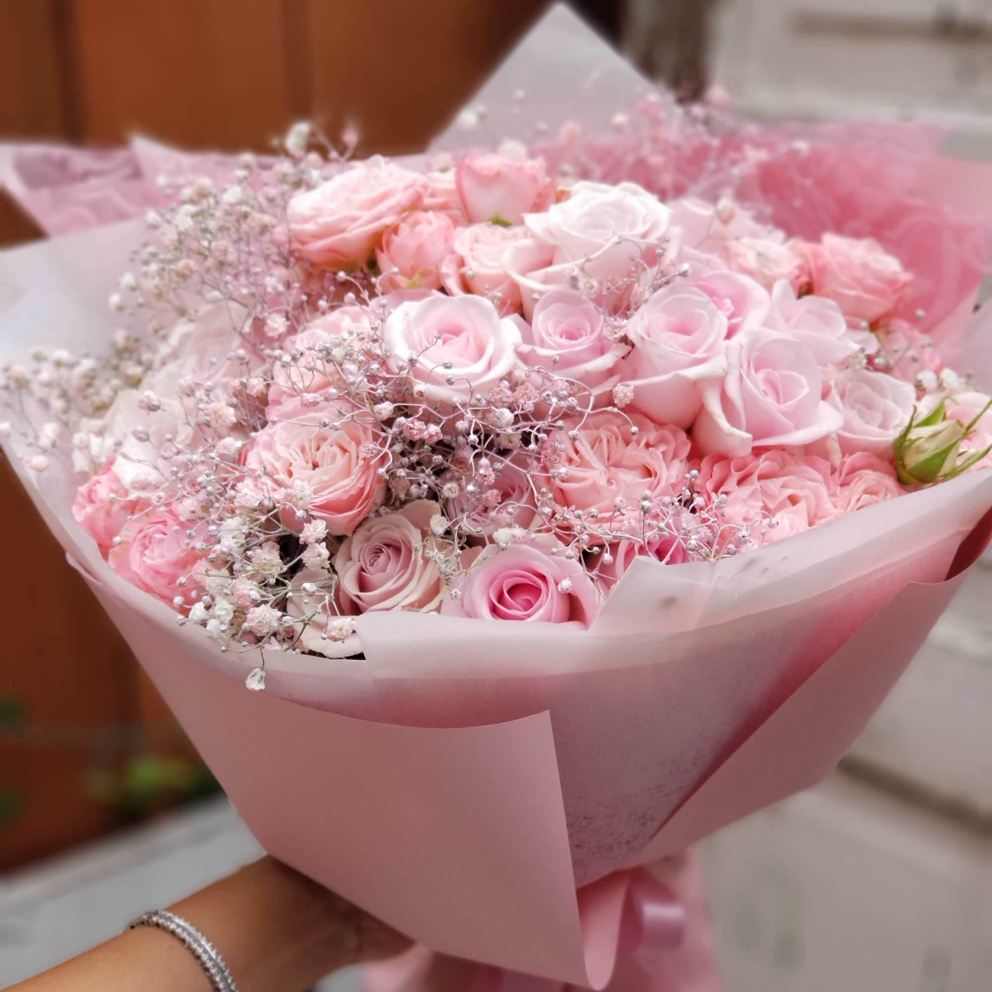 Pink rose bouquet wrapped in pale pink paper, photo 3 of 3