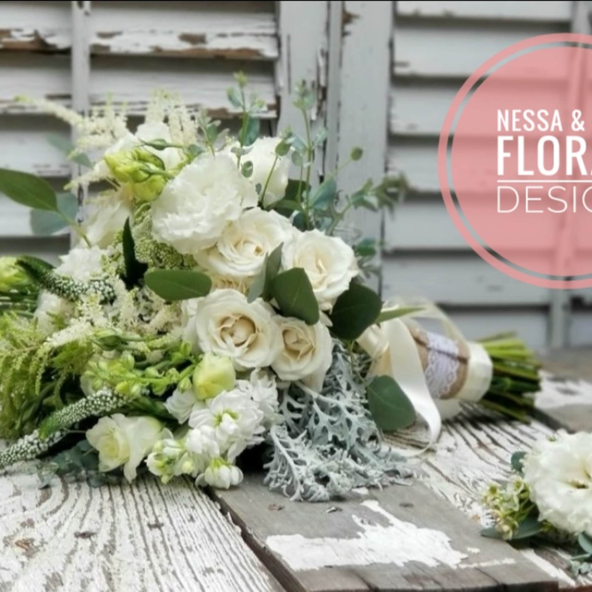 White rose bouquet with green accents and a ribbon wrap