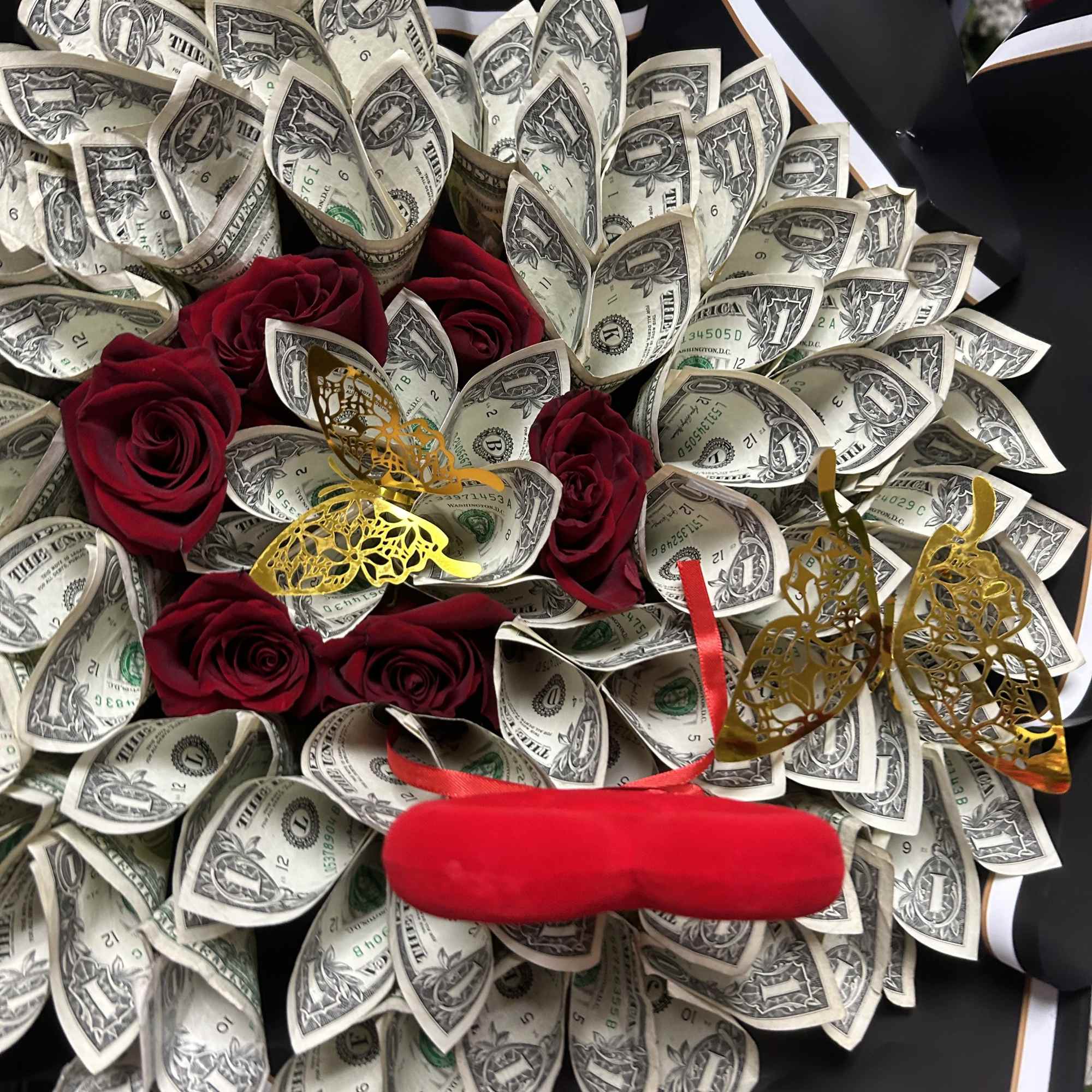 Bouquet of dollar bills with red roses and butterfly decorations