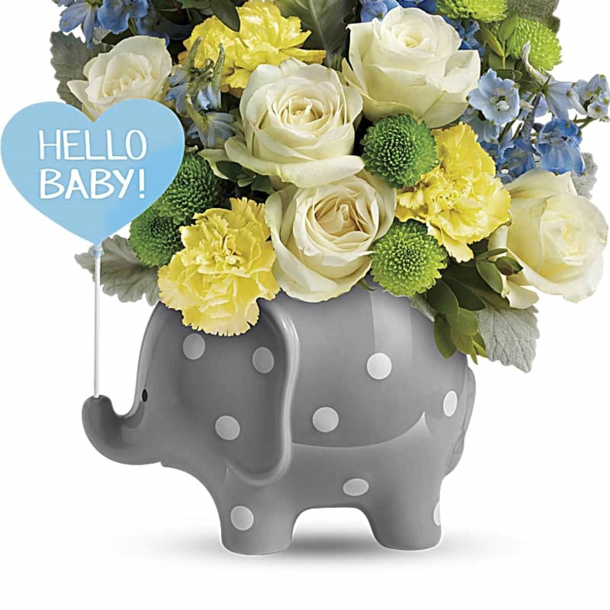 Yellow and white roses and carnations in a gray polka dot elephant vase with a blue 'Hello Baby' heart pick.