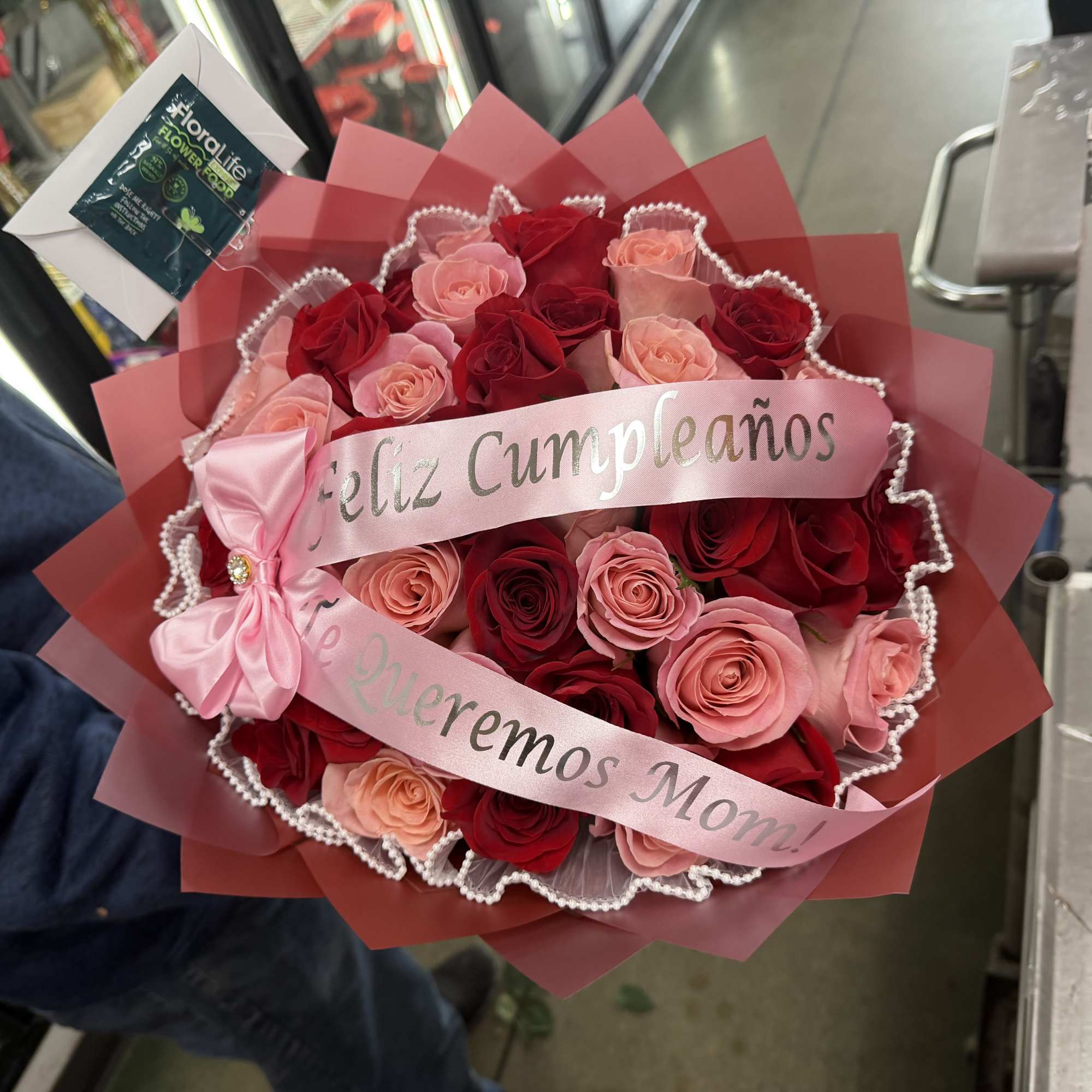 Bouquet of red and pink roses with a pink birthday ribbon