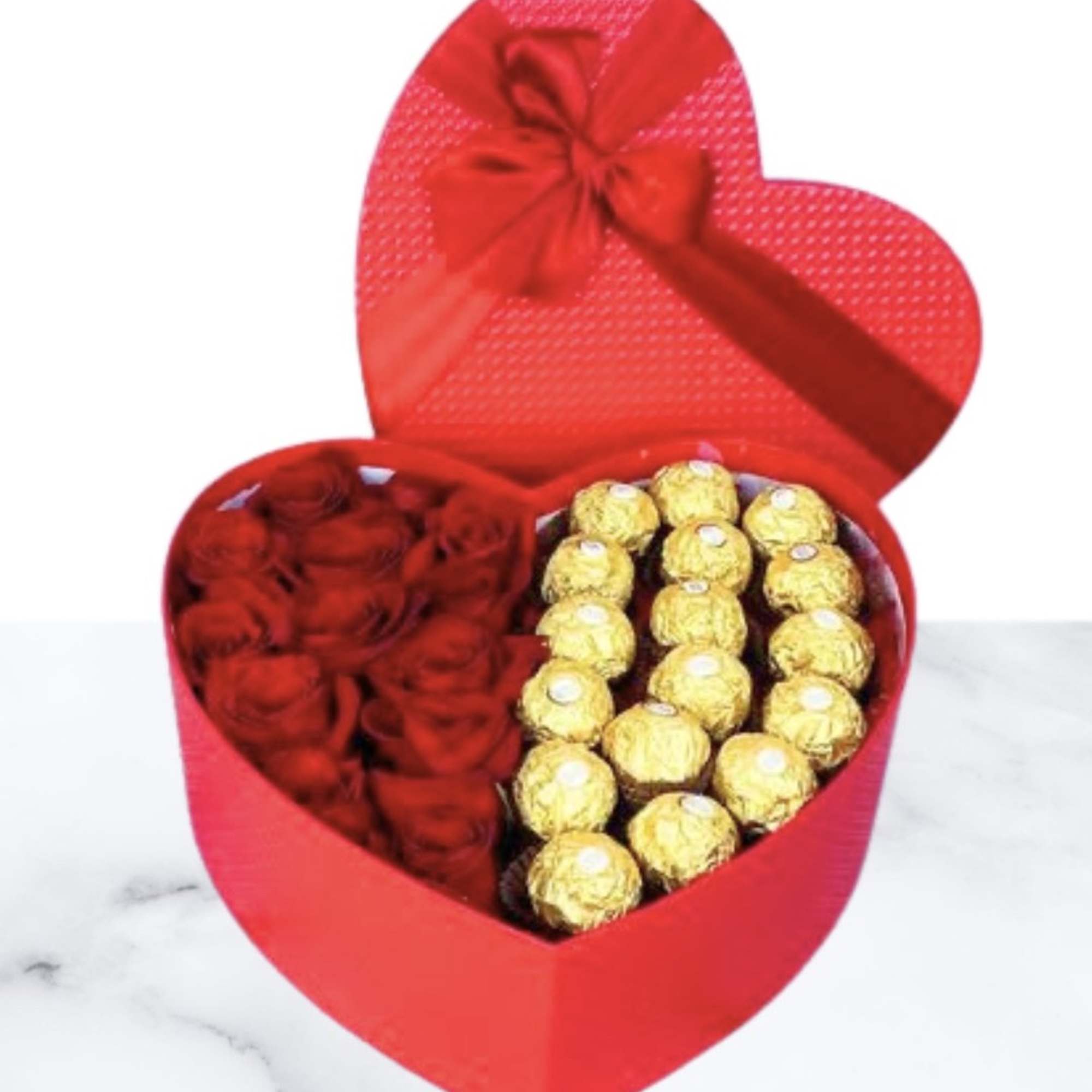 Heart-shaped red gift box with red roses and gold-wrapped chocolates