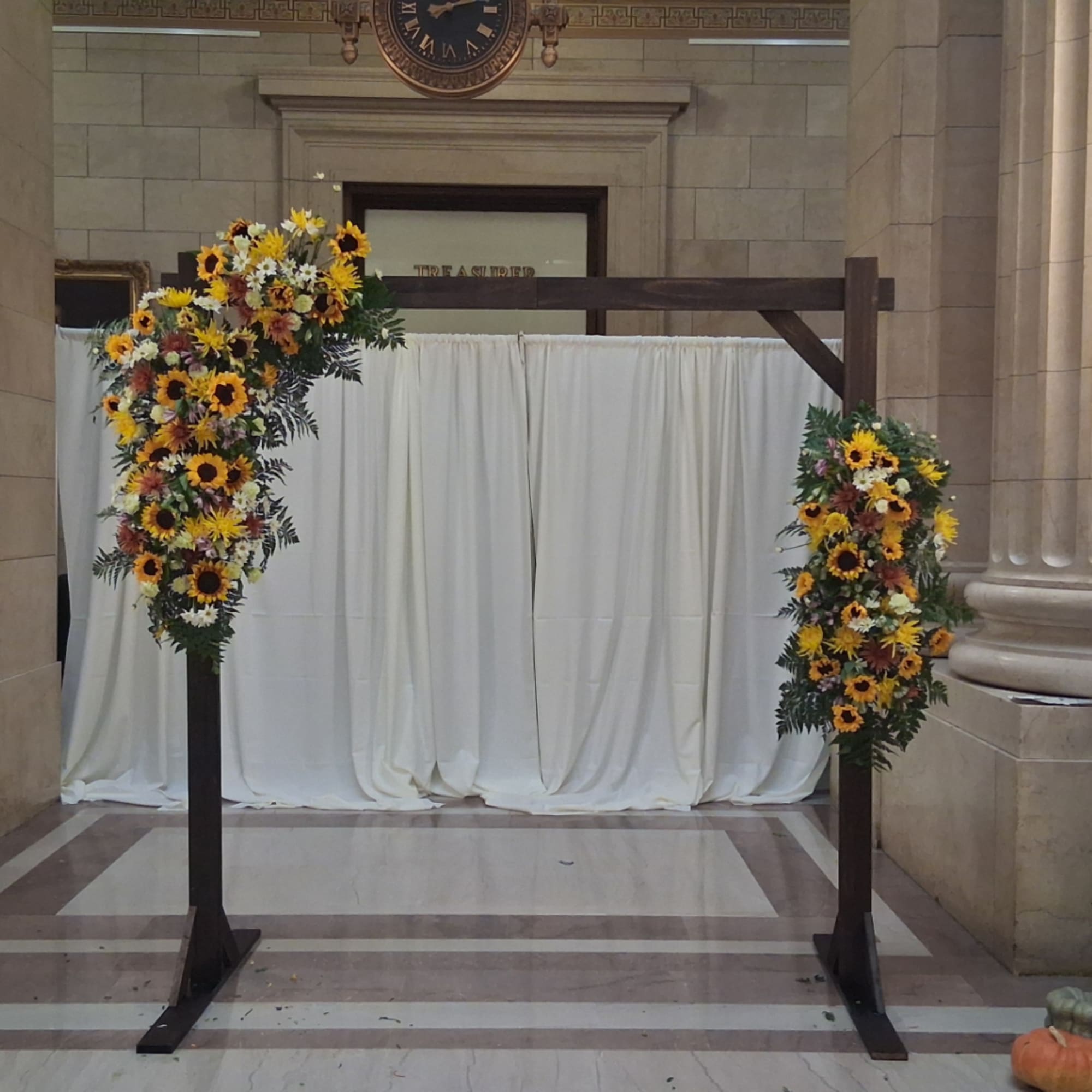 Sunflower floral arch with white daisies on a wooden frame