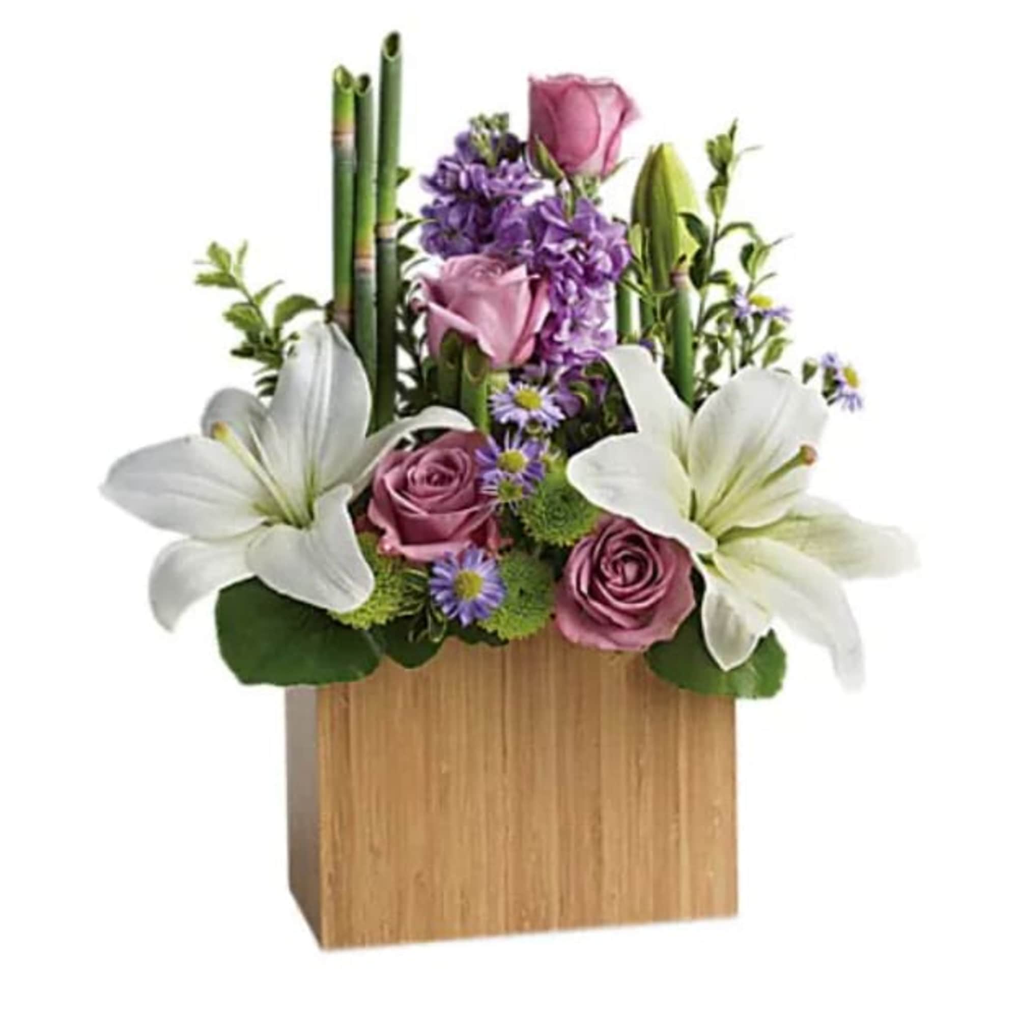 Pink roses and white lilies arranged in a wooden box with purple flowers