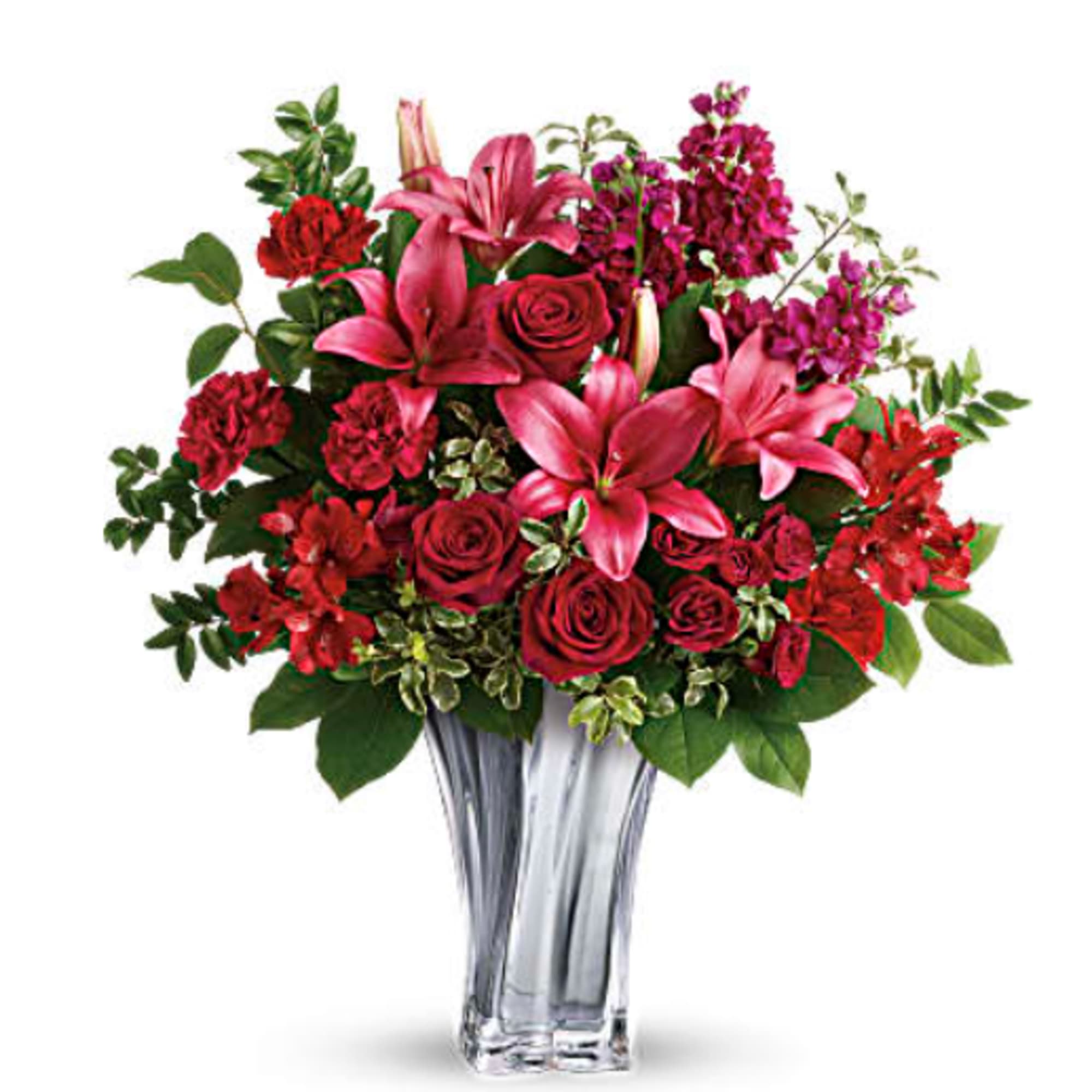 Red roses and pink lilies in a clear glass vase