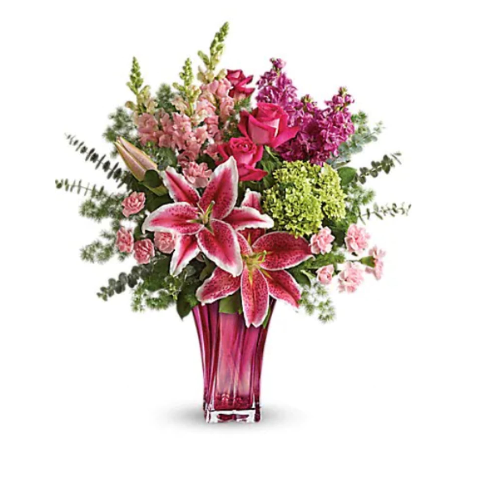 Pink and magenta floral arrangement in a tall glass vase