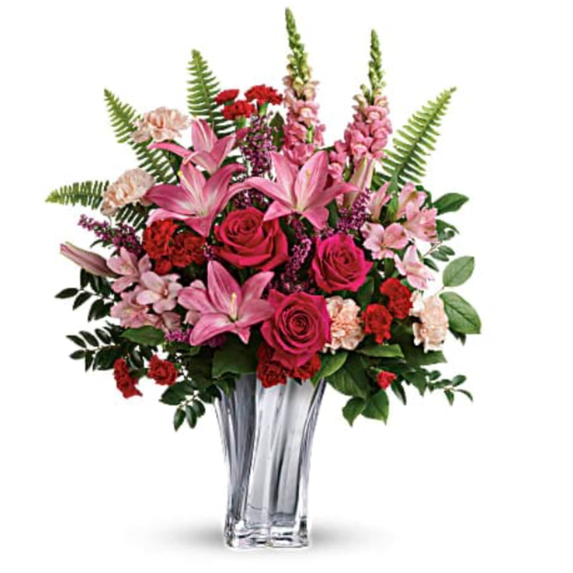 Bouquet of pink lilies, roses, and carnations in a clear glass vase
