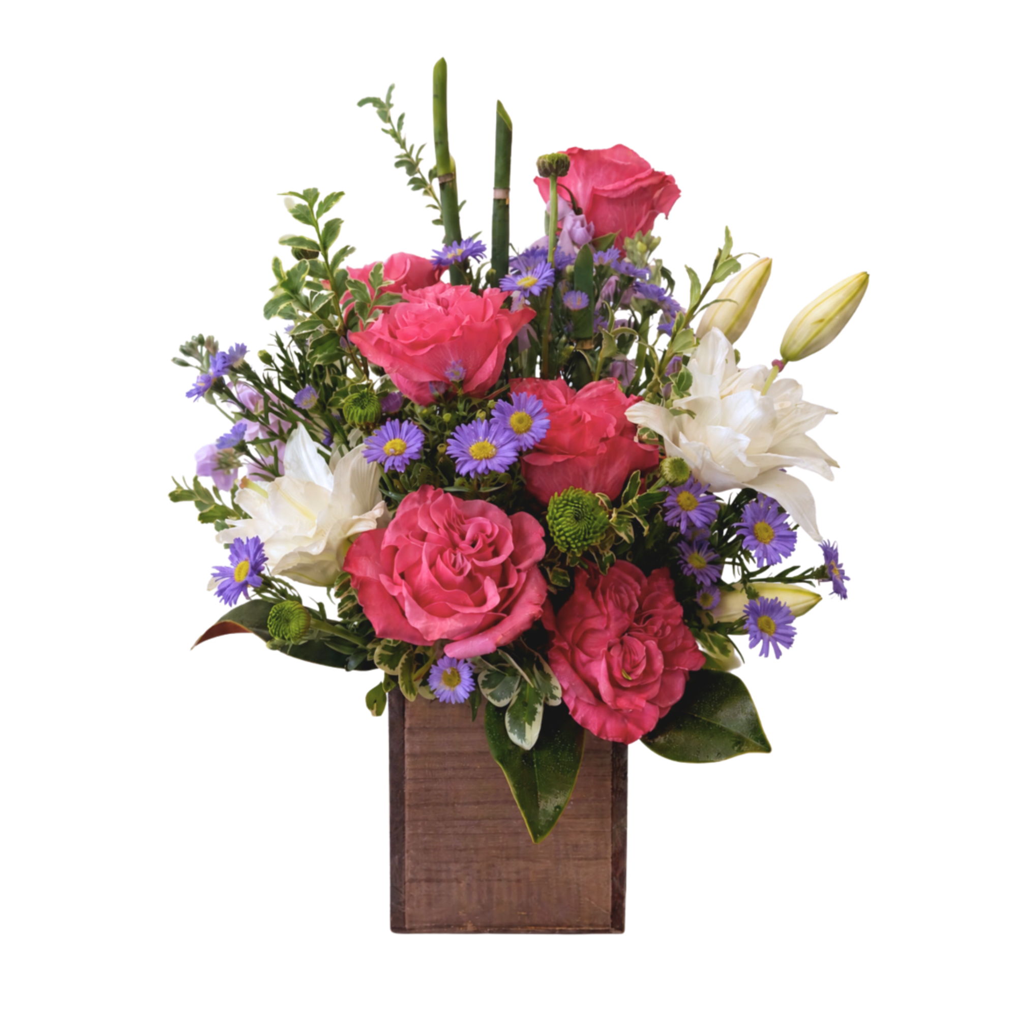 Pink roses and white lilies in a wooden box with purple daisies