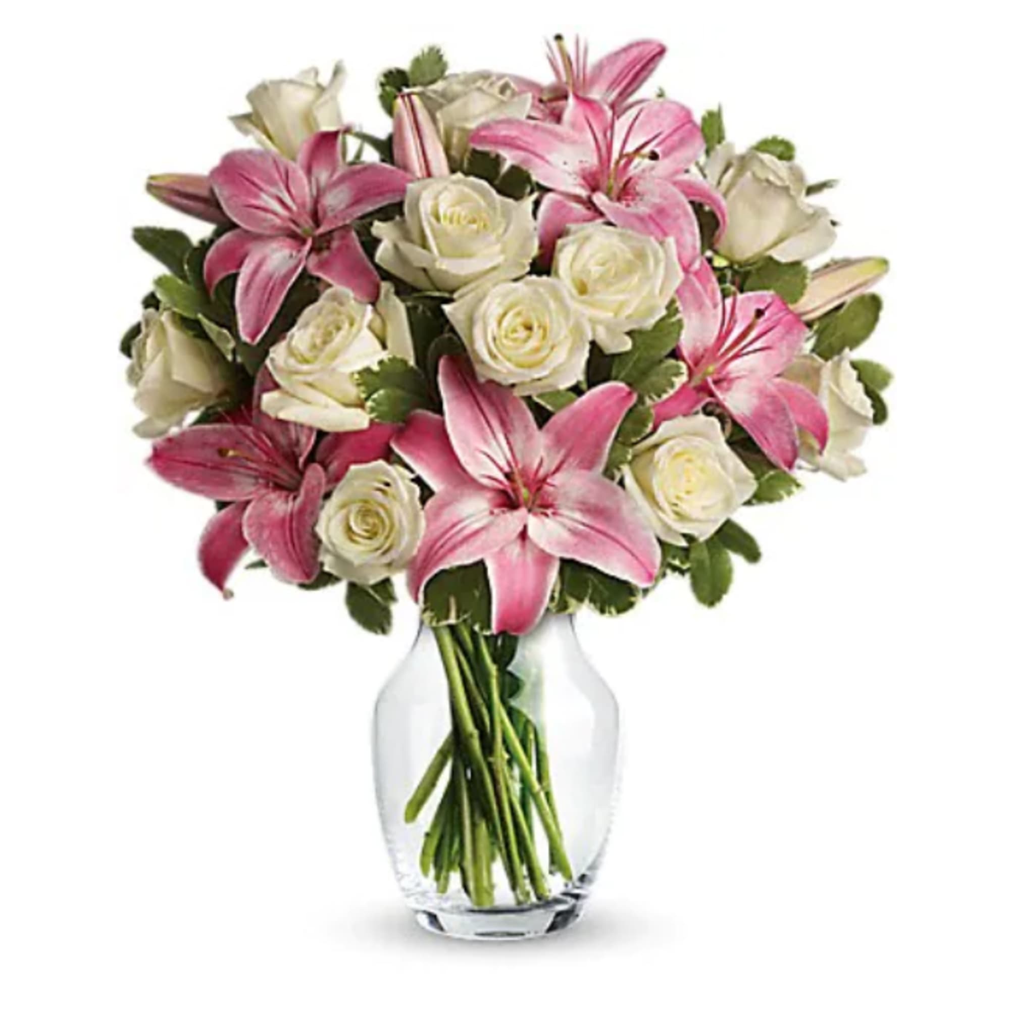 Pink lilies and white roses arranged in a clear glass vase