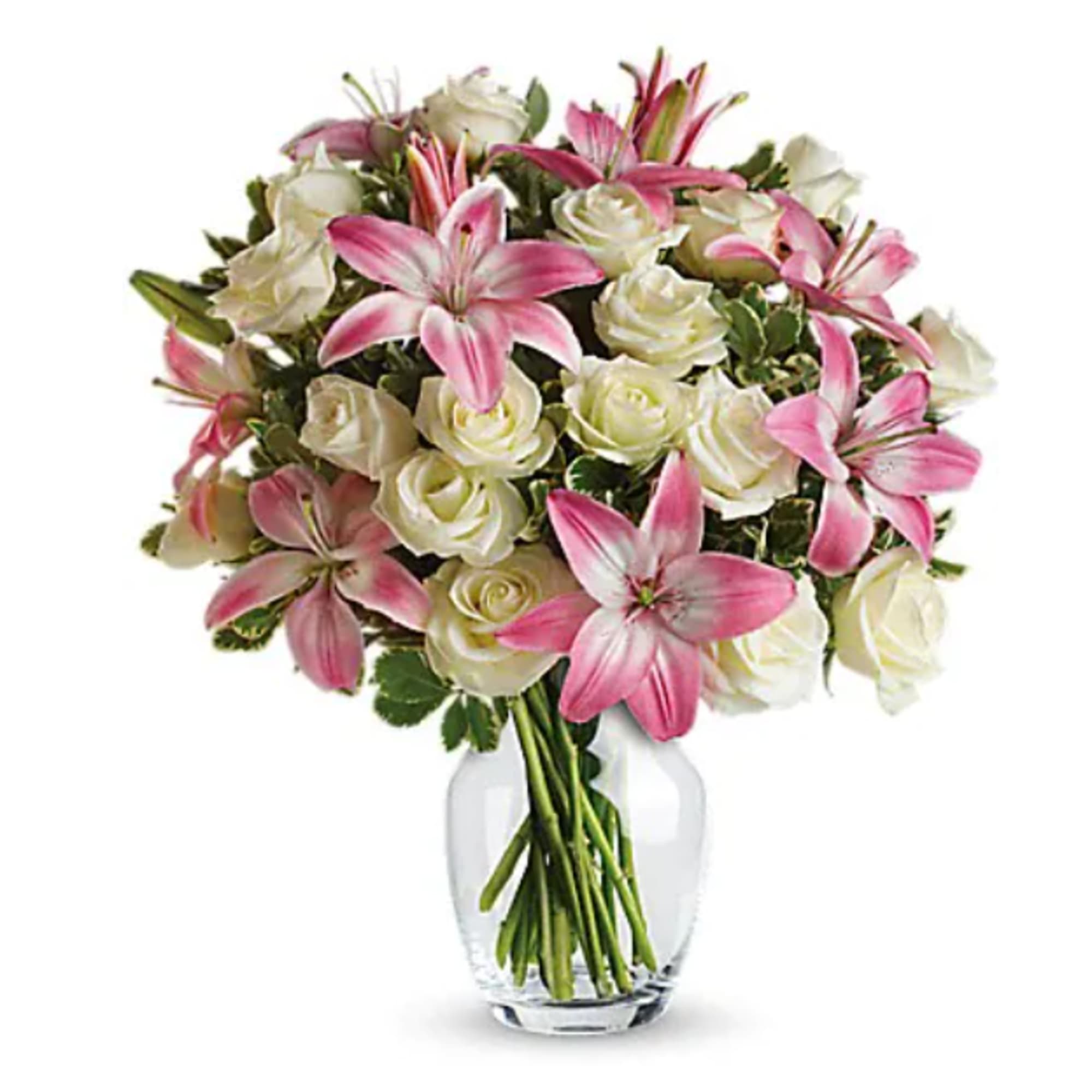 Pink lilies and white roses arranged in a clear glass vase