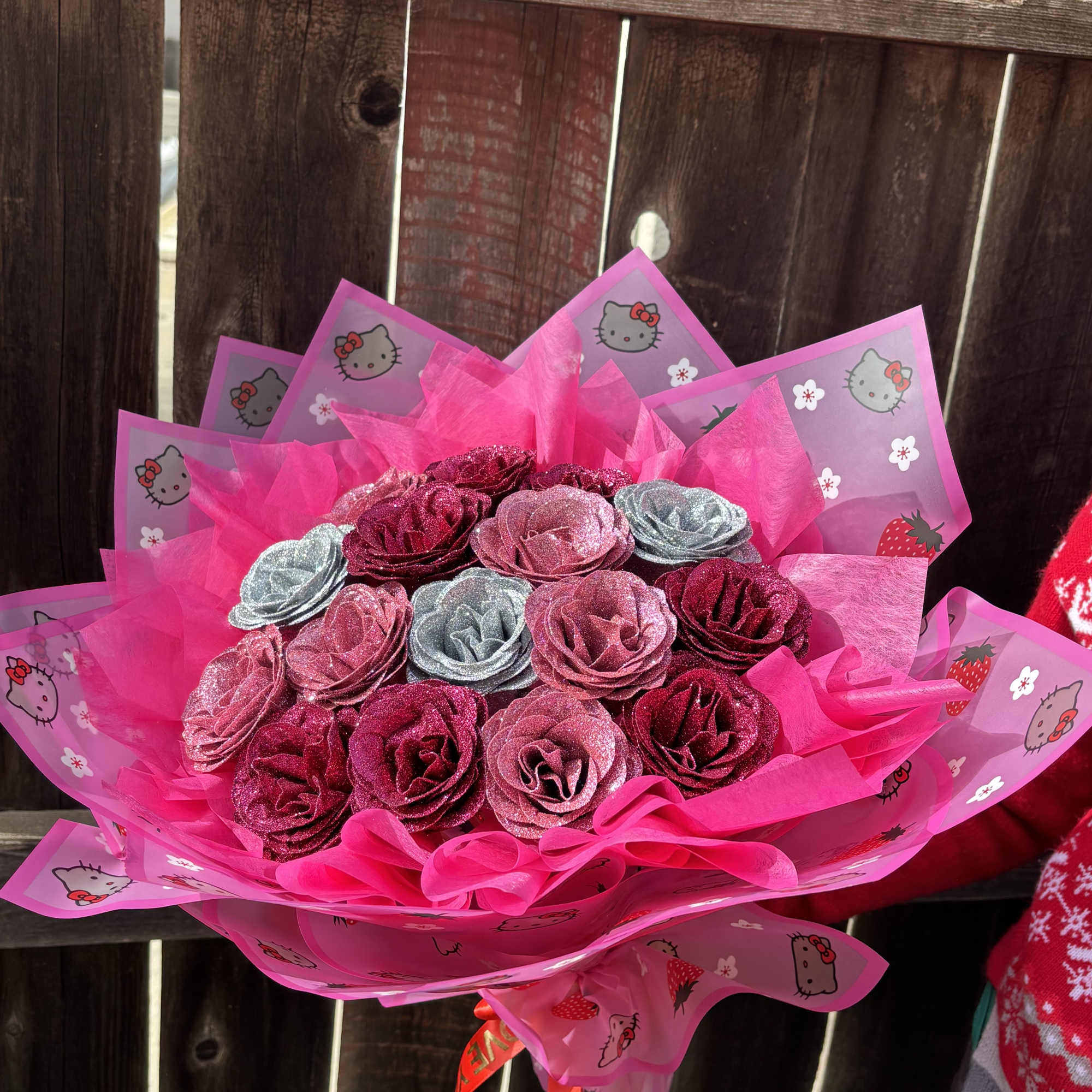Bouquet of glittery pink and silver roses wrapped in bright pink paper
