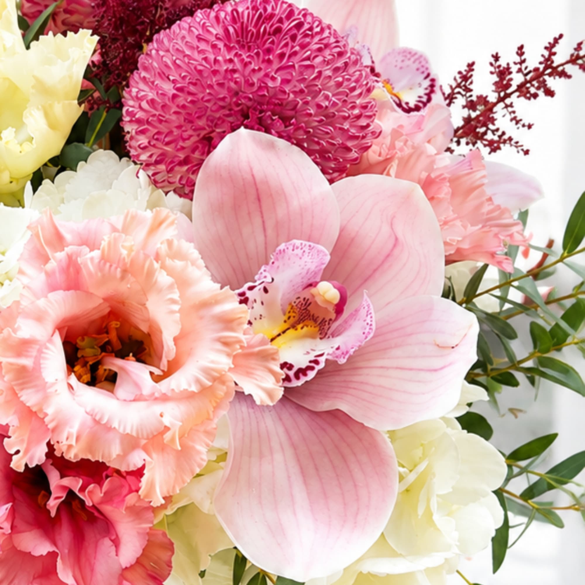 Pink and white floral bouquet with orchids and ruffled blooms