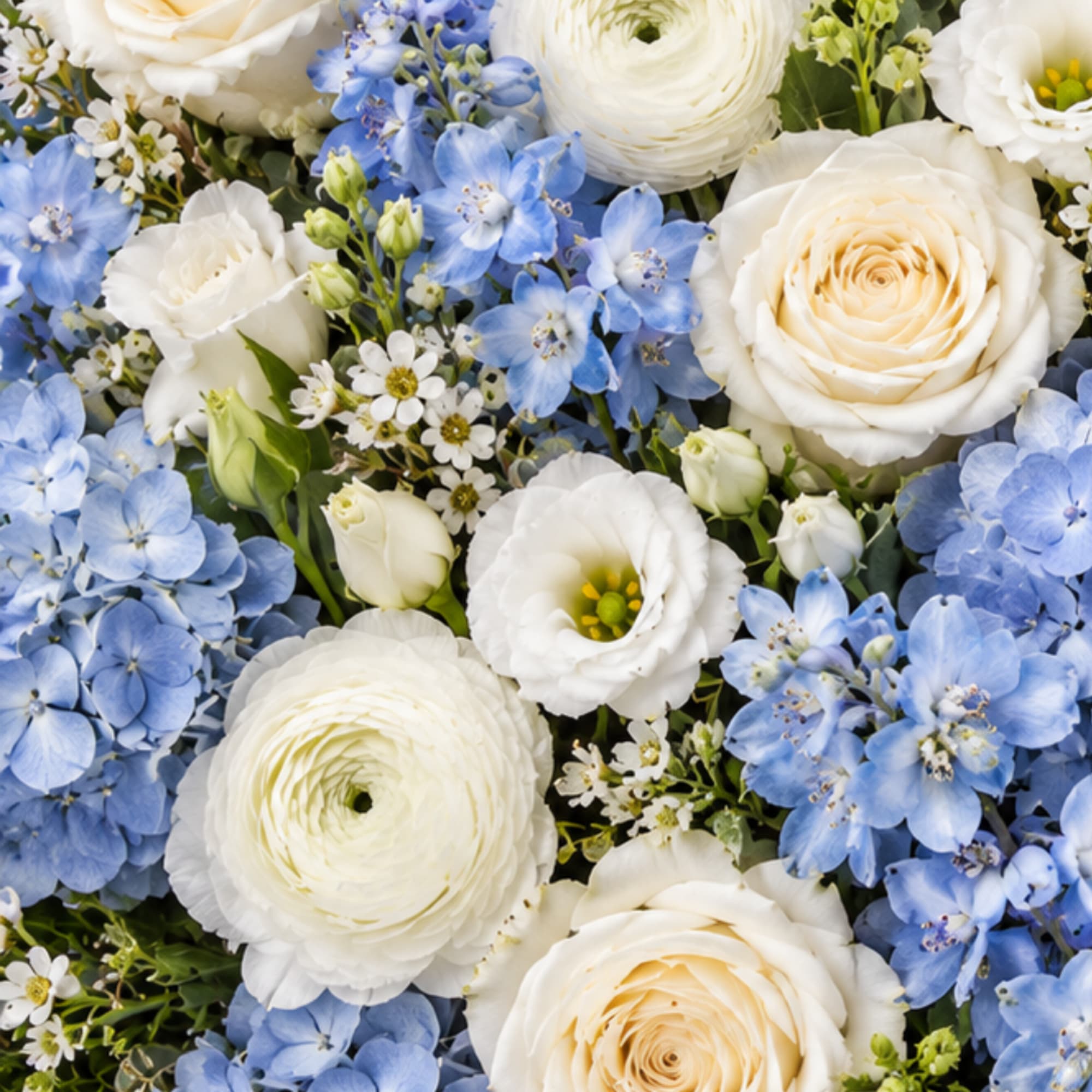 Blue and white floral arrangement with roses and ranunculus