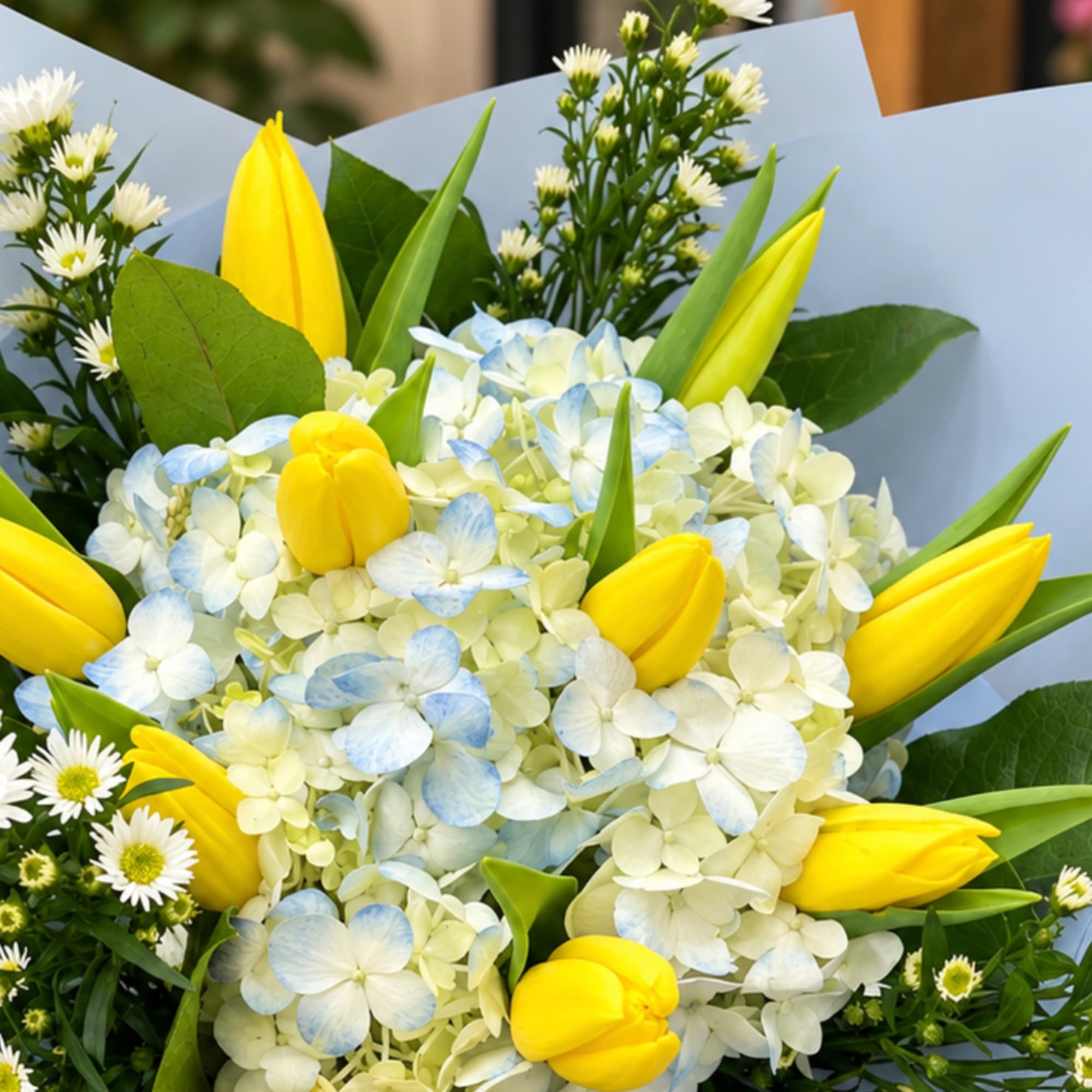 Bouquet of yellow tulips and pale blue hydrangeas with white daisies, photo 3 of 3