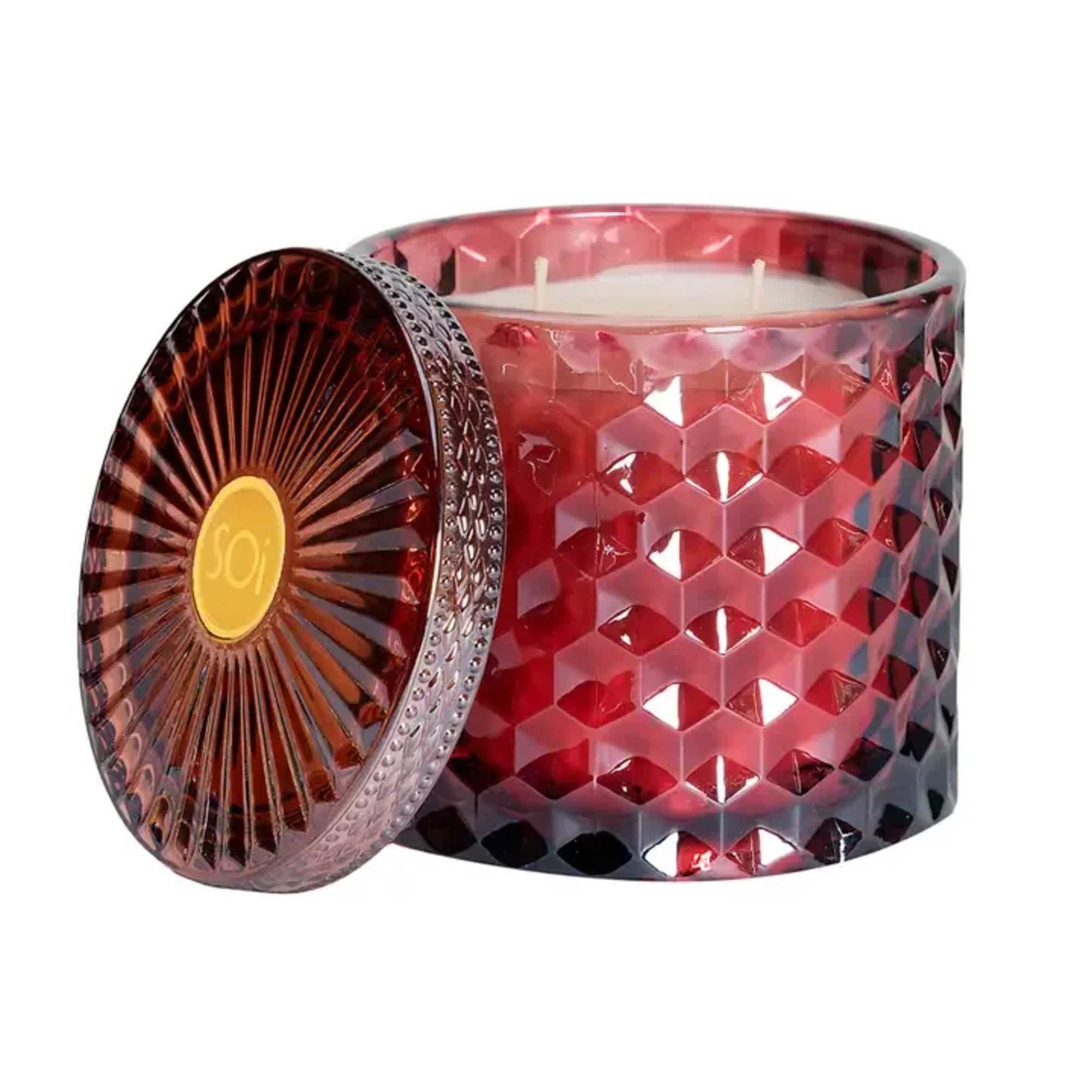 Red glass candle jar with a lid on a white background