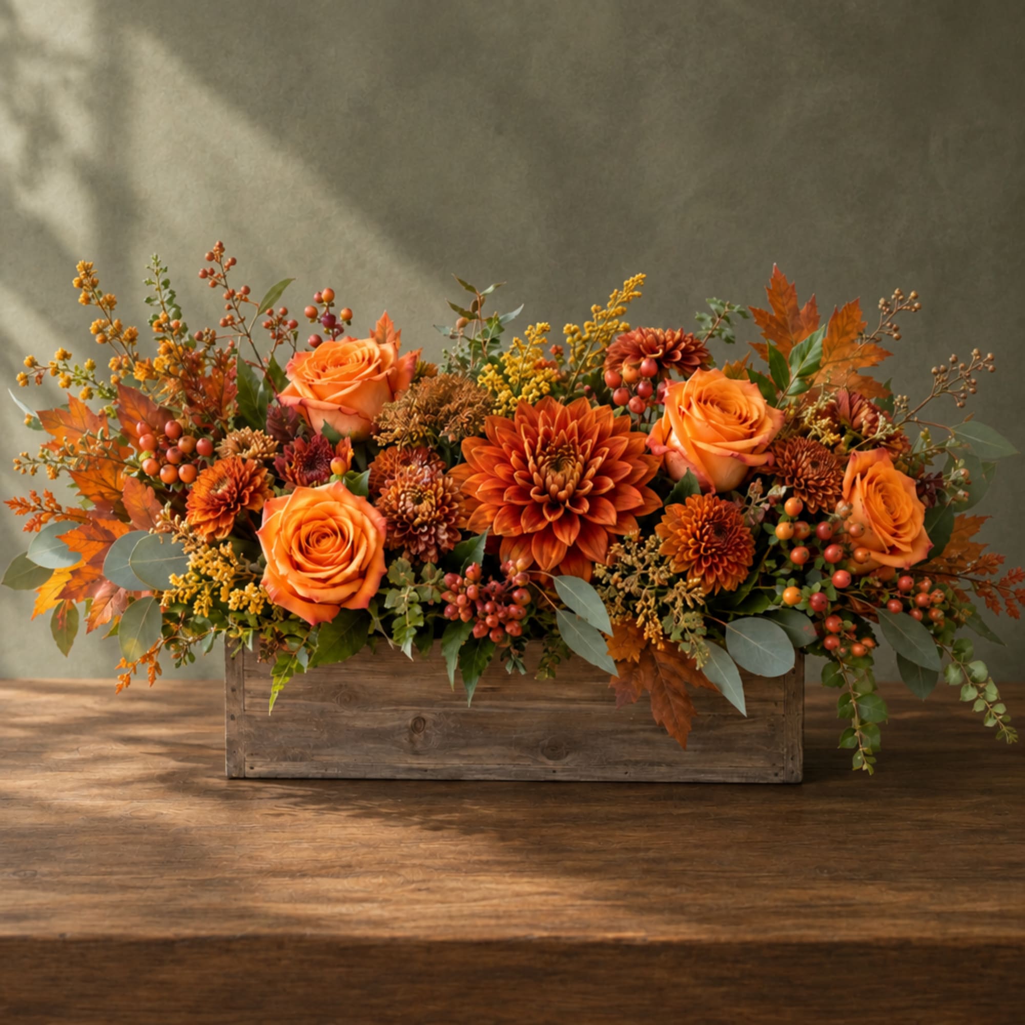 Orange roses and mums arranged in a rustic wooden box