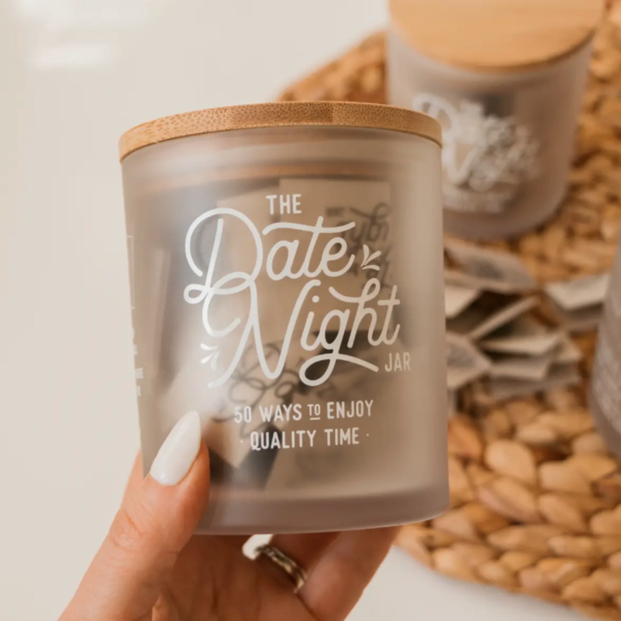 Frosted glass candle jar with a bamboo lid and printed text