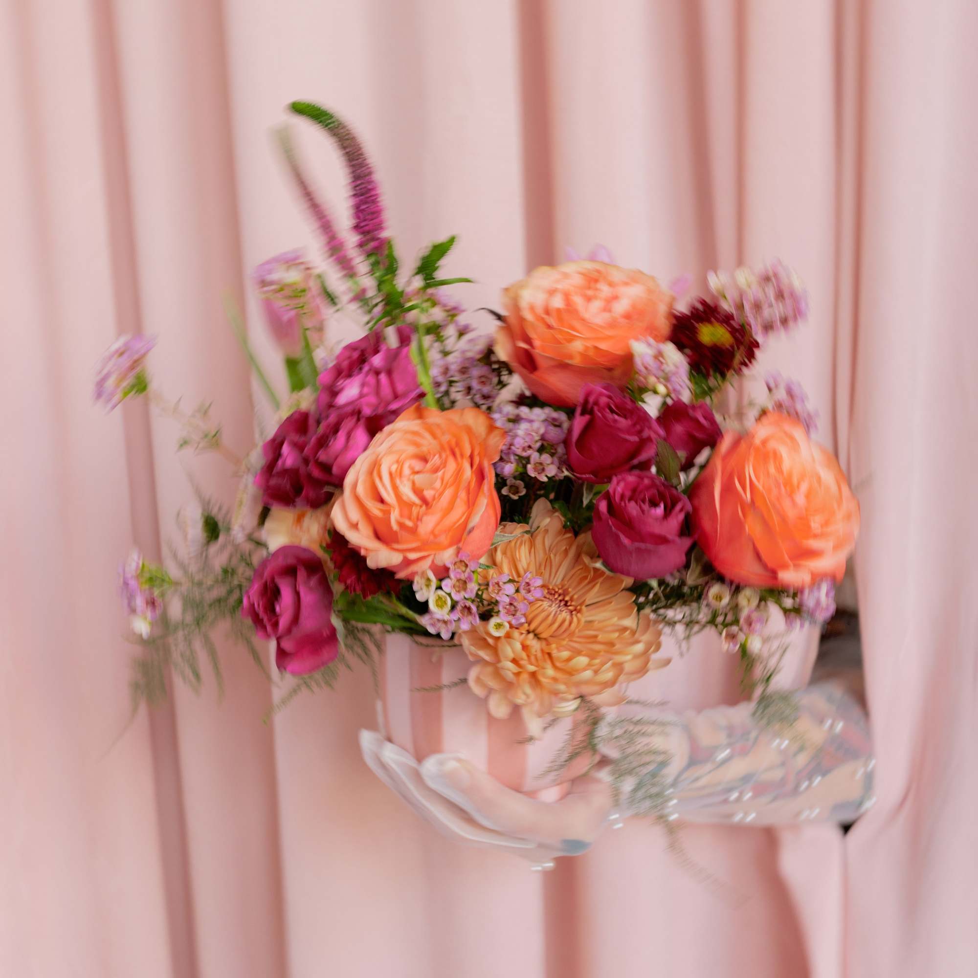 Pink and peach rose bouquet in a clear vase