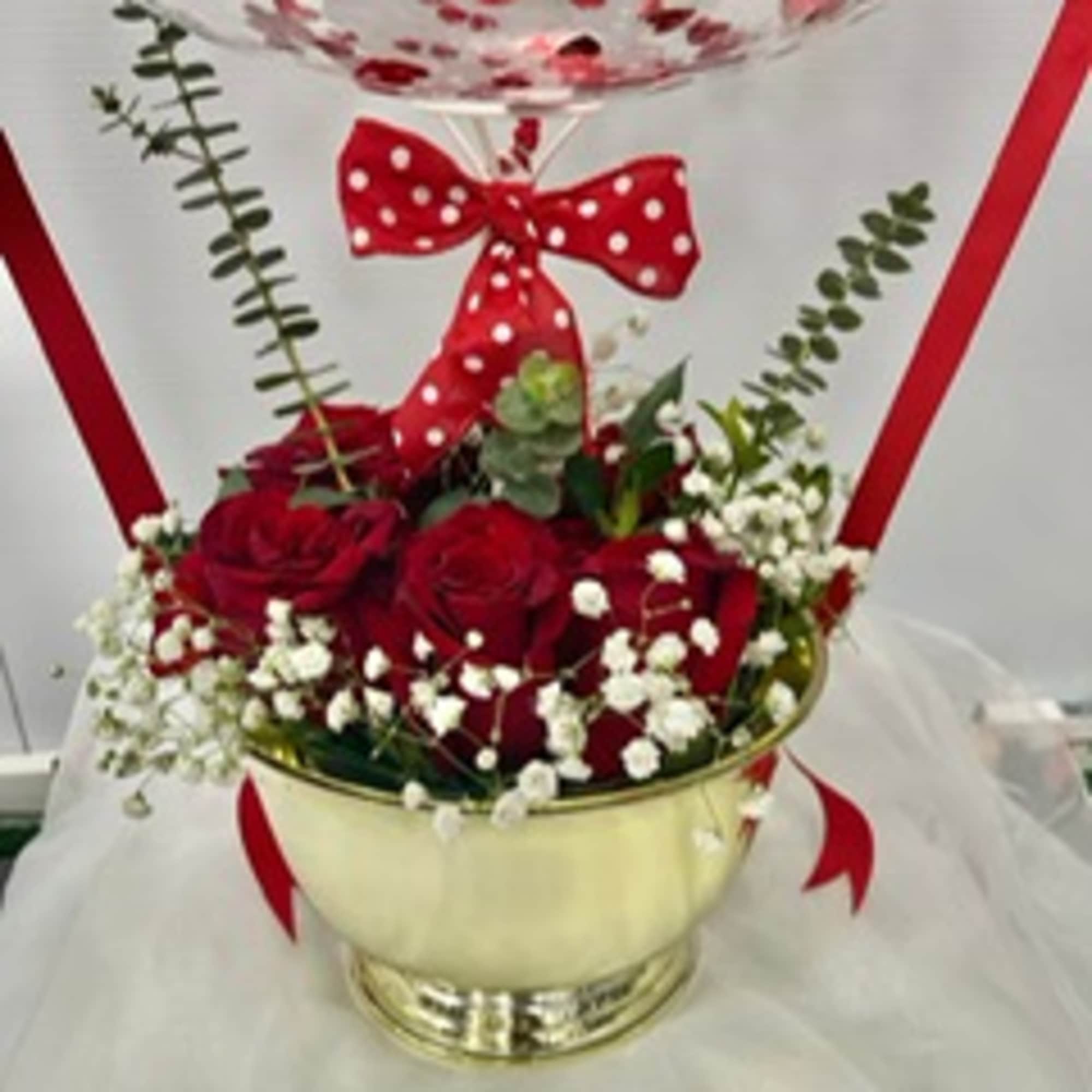 Red roses in a gold bowl with baby's breath and a red polka-dot bow