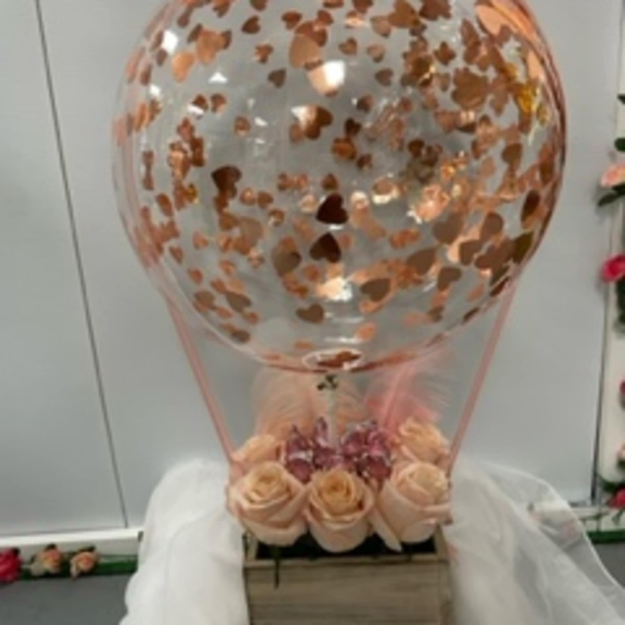 Rose bouquet in a wooden box with a clear heart balloon