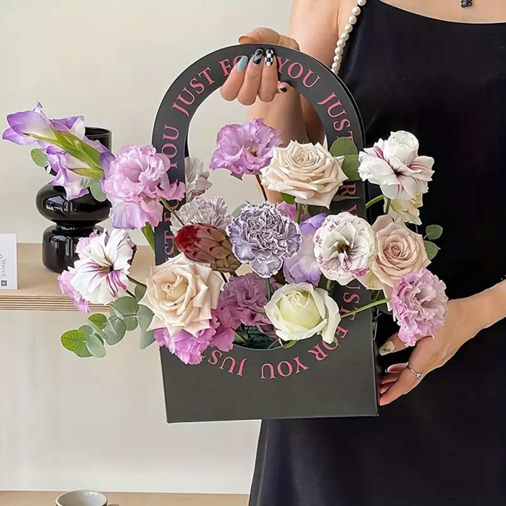 Handheld floral gift bag with pastel roses and carnations