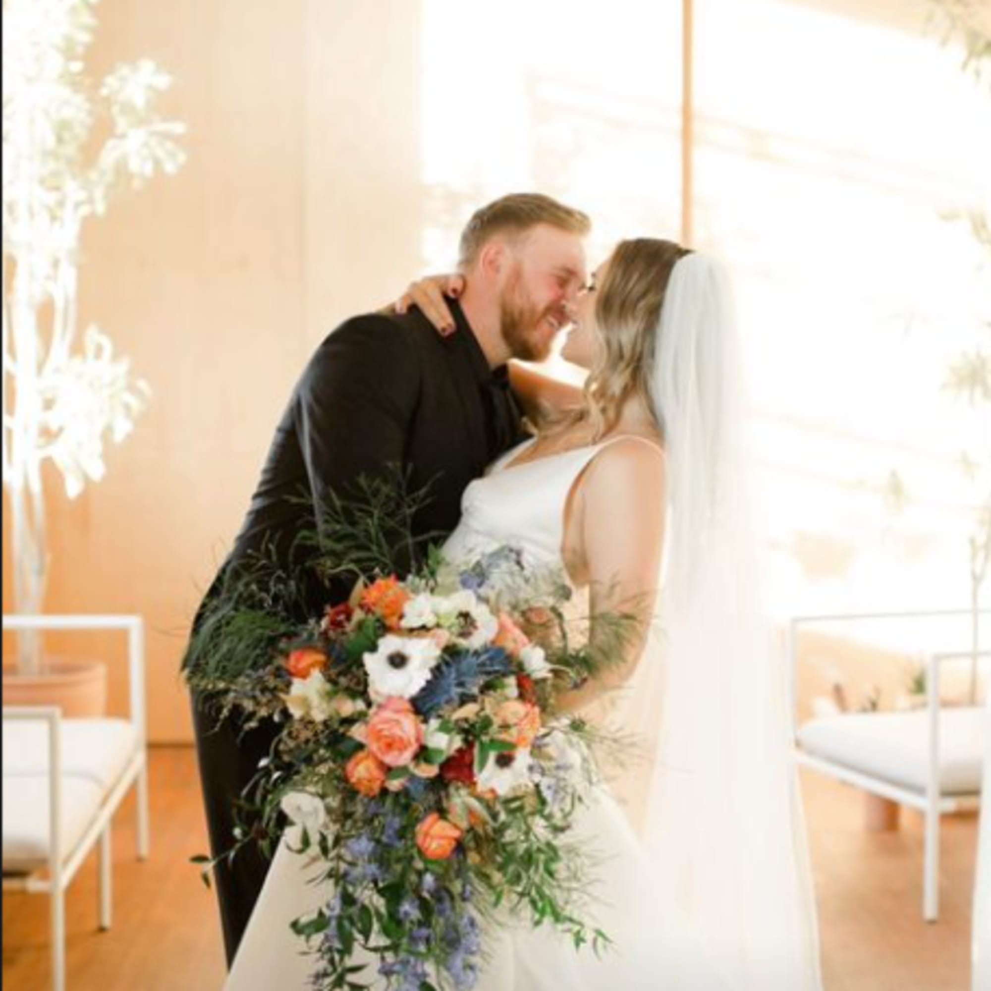 Bride and groom holding a cascading wedding bouquet