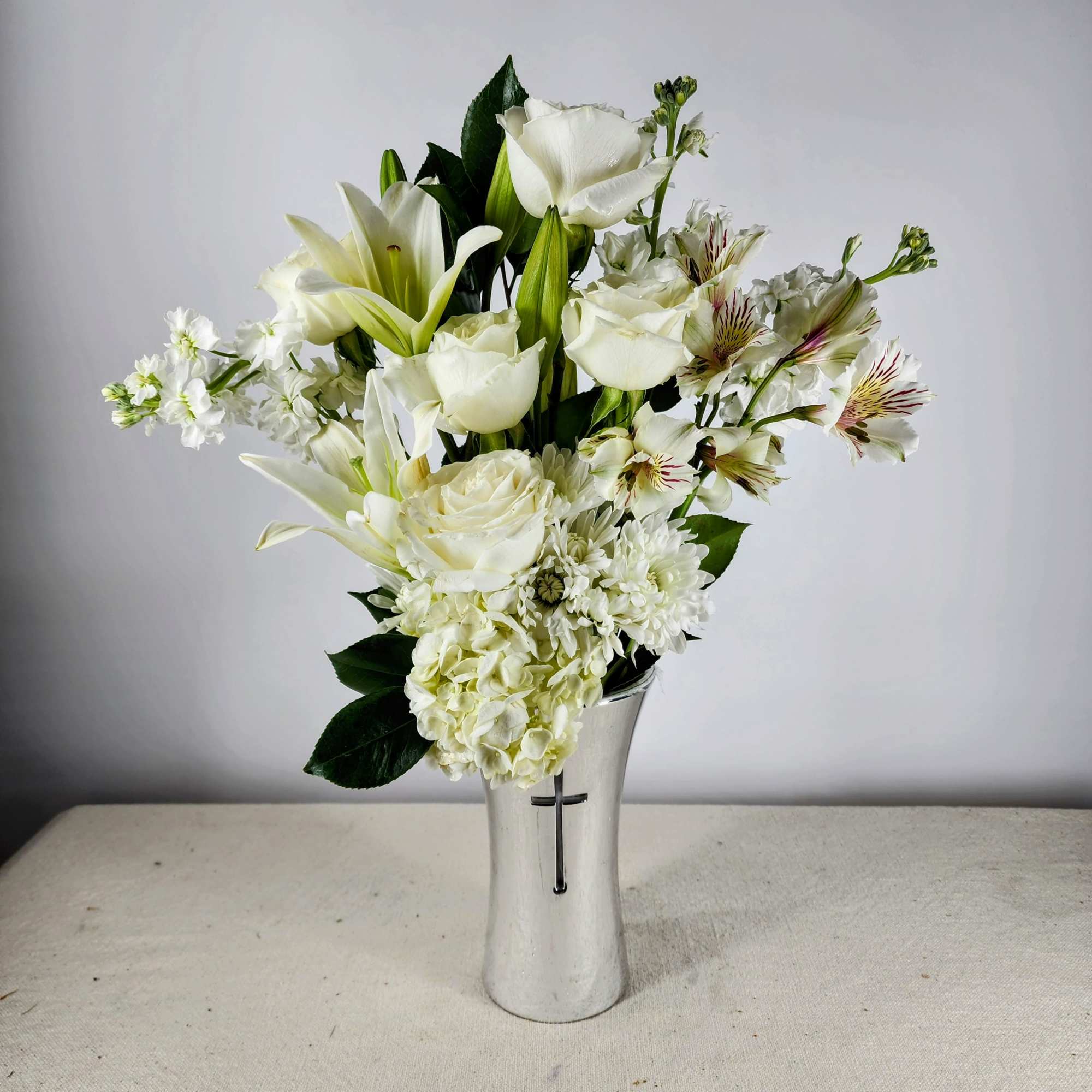 White floral arrangement in a silver vase