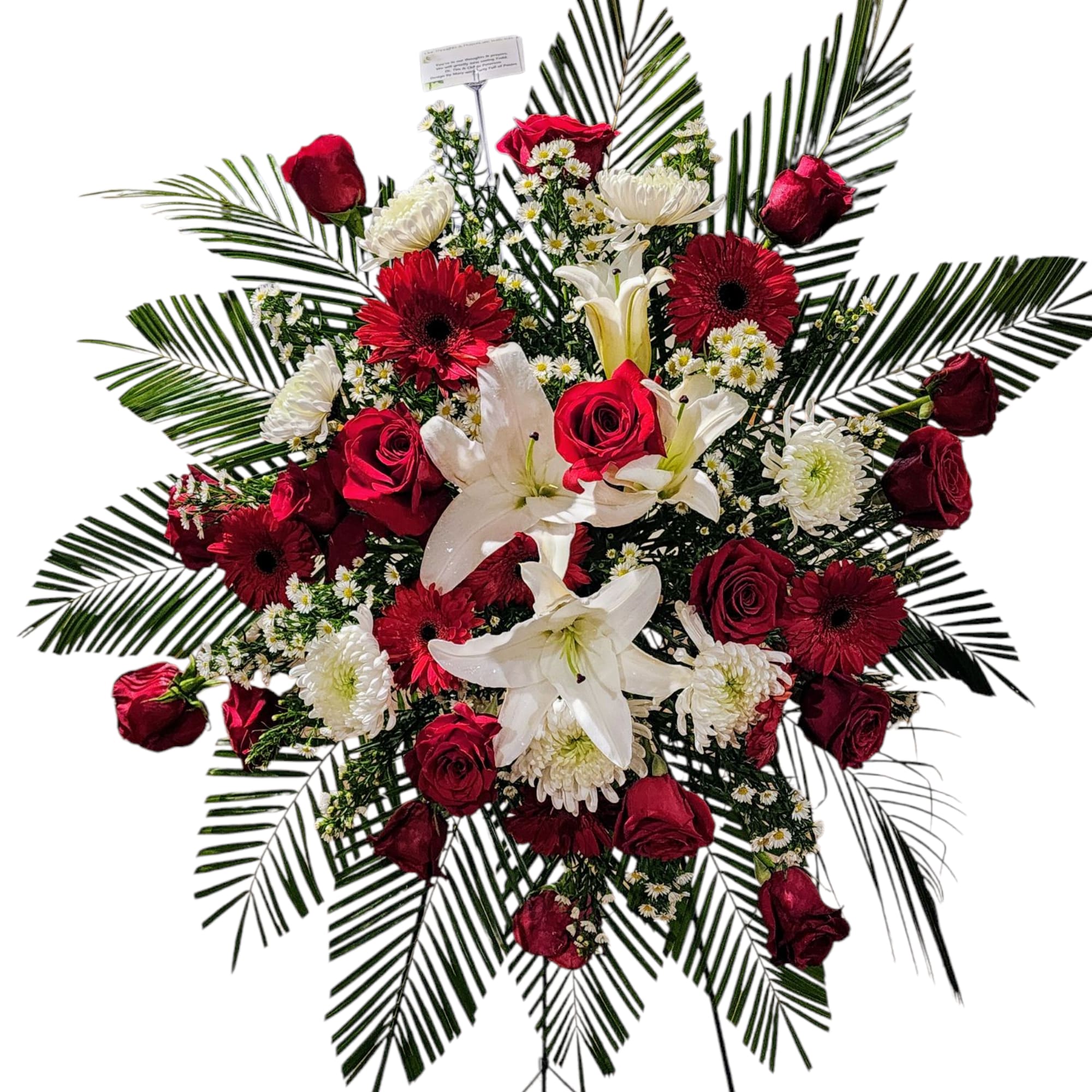 Standing floral spray with red roses, white lilies, and palm fronds
