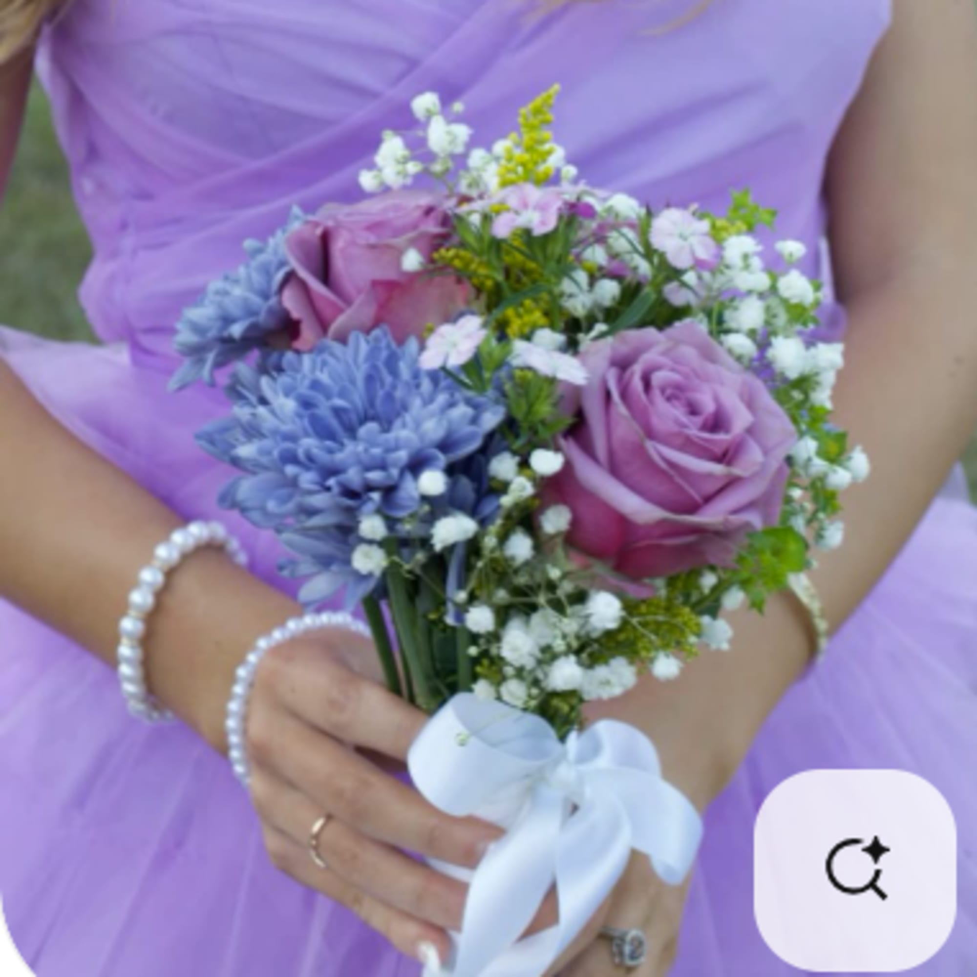 Bridal bouquet of lavender roses and blue flowers with white ribbon