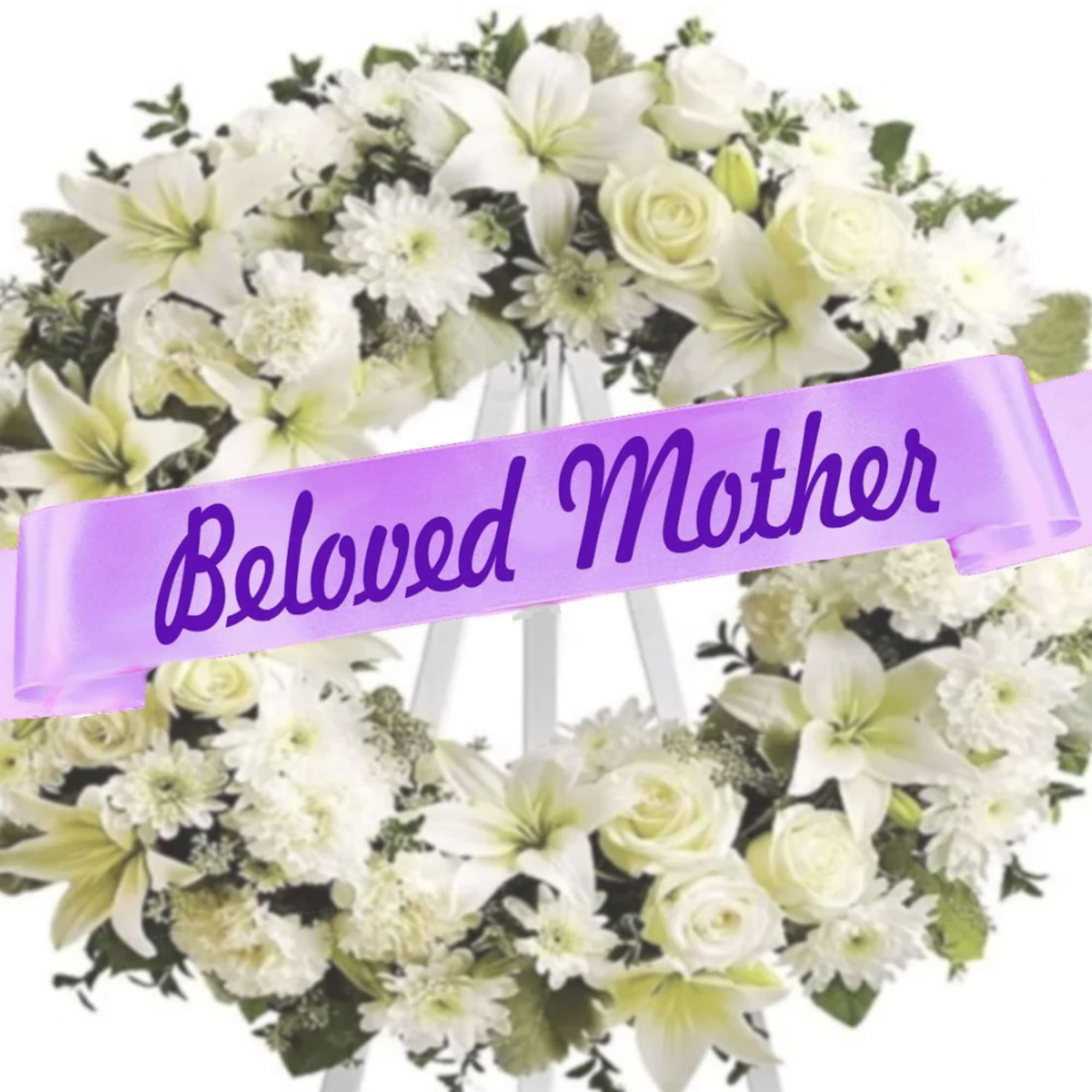White floral wreath on an easel with a purple ribbon reading Beloved Mother