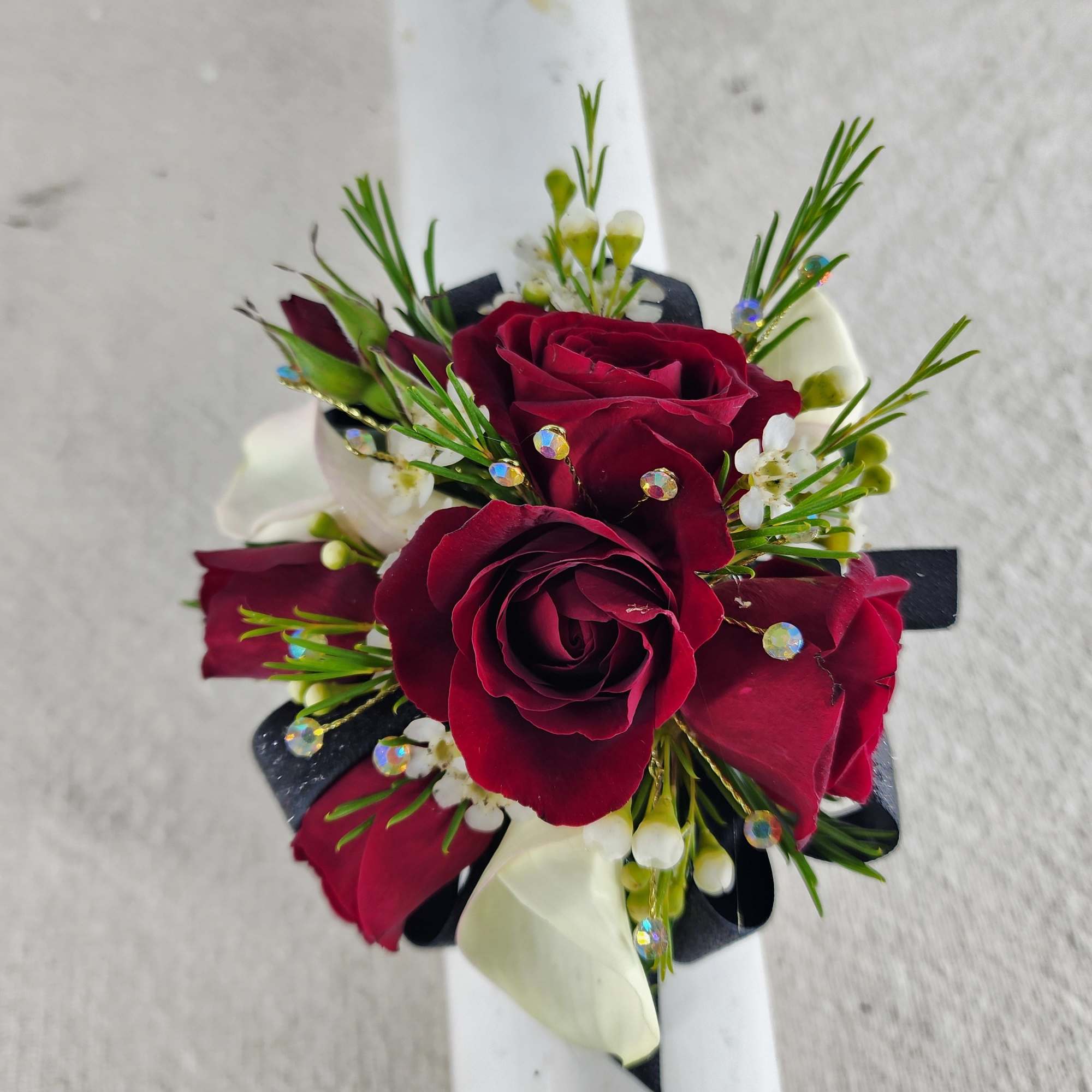 Make a striking statement with this elegant prom corsage featuring rich red