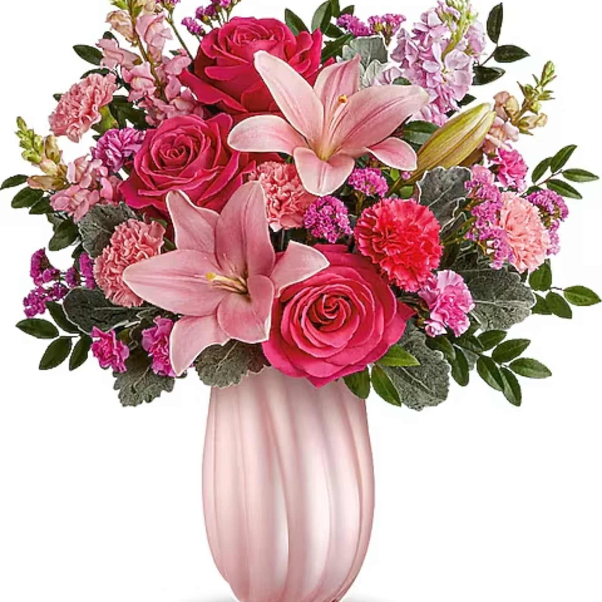 Pink roses and lilies arranged in a blush vase