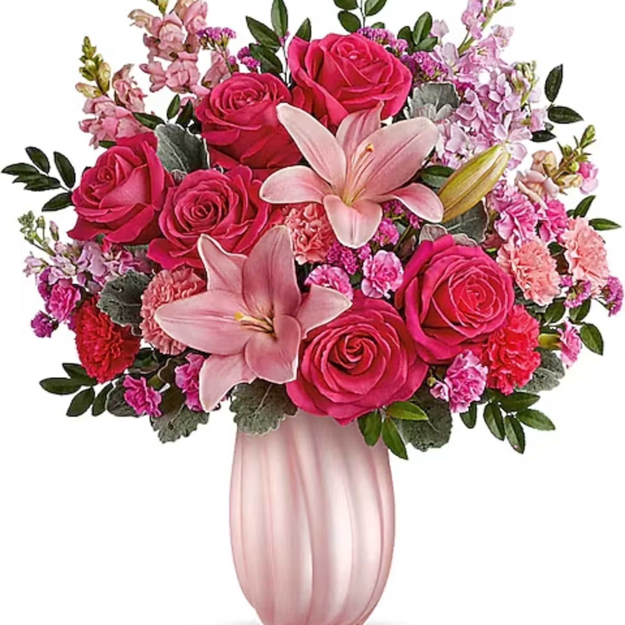 Pink roses and lilies arranged in a blush vase