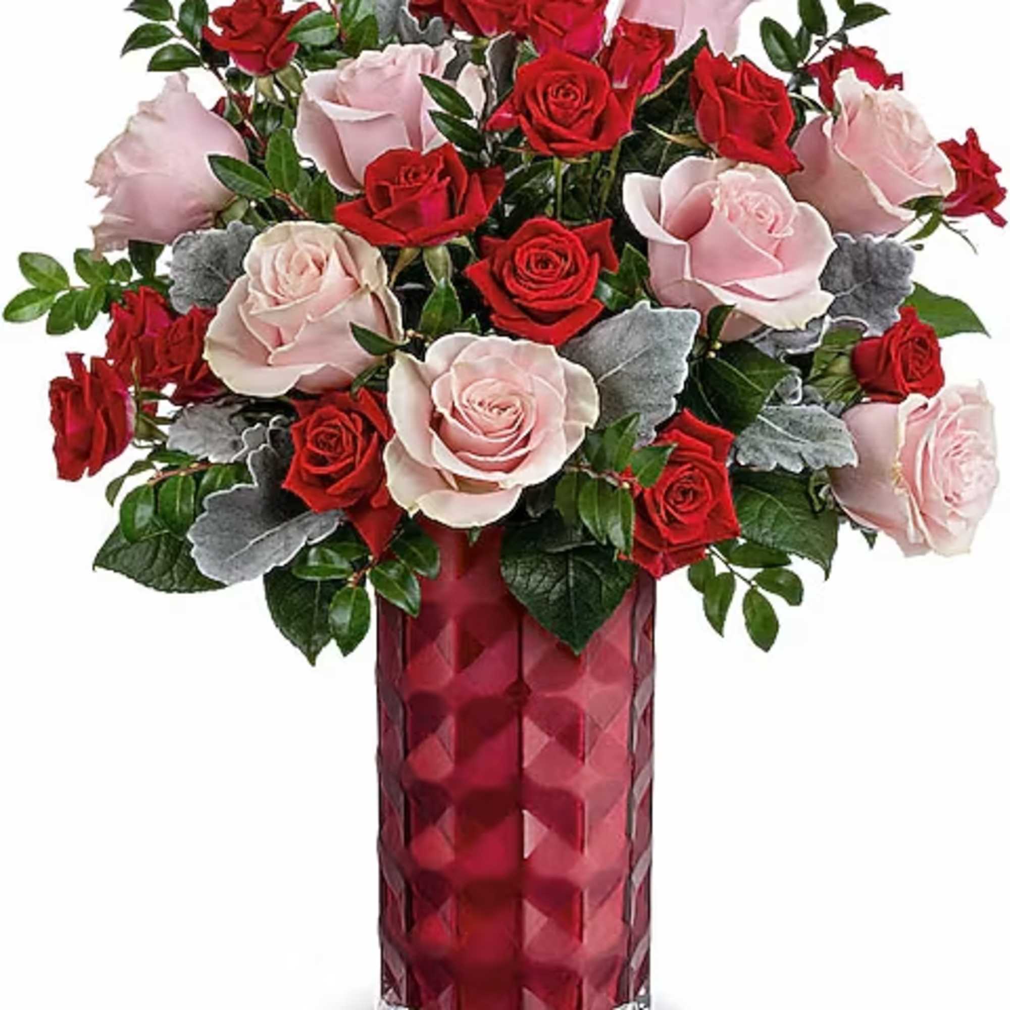 Red and pale pink roses arranged in a tall red vase
