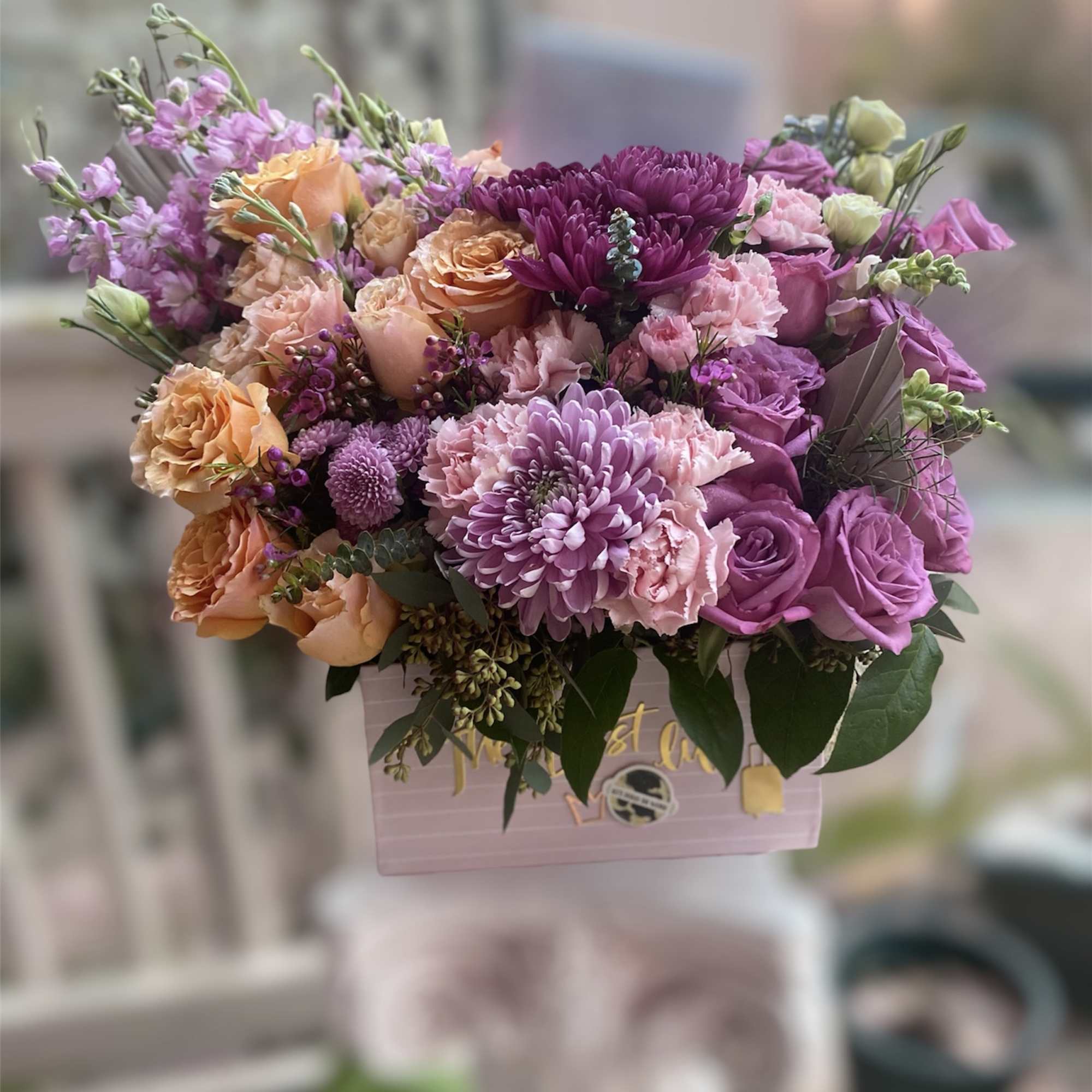 Lush box of florals with hues of purples, pinks and muted colors.