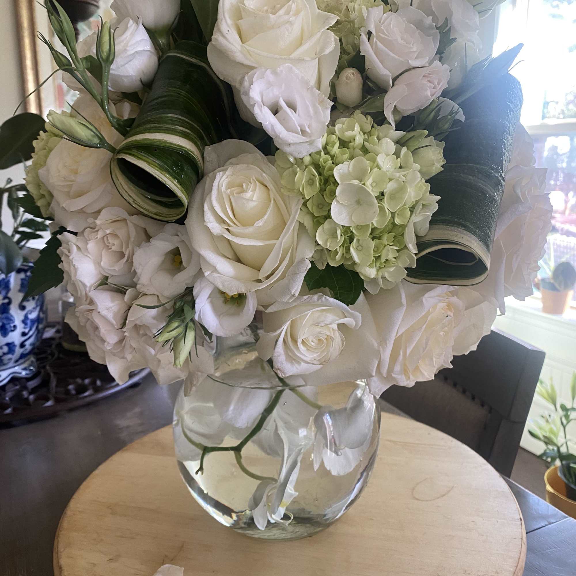 A medley of white mondial roses with luxury accent florals and Ti, photo 2 of 2
