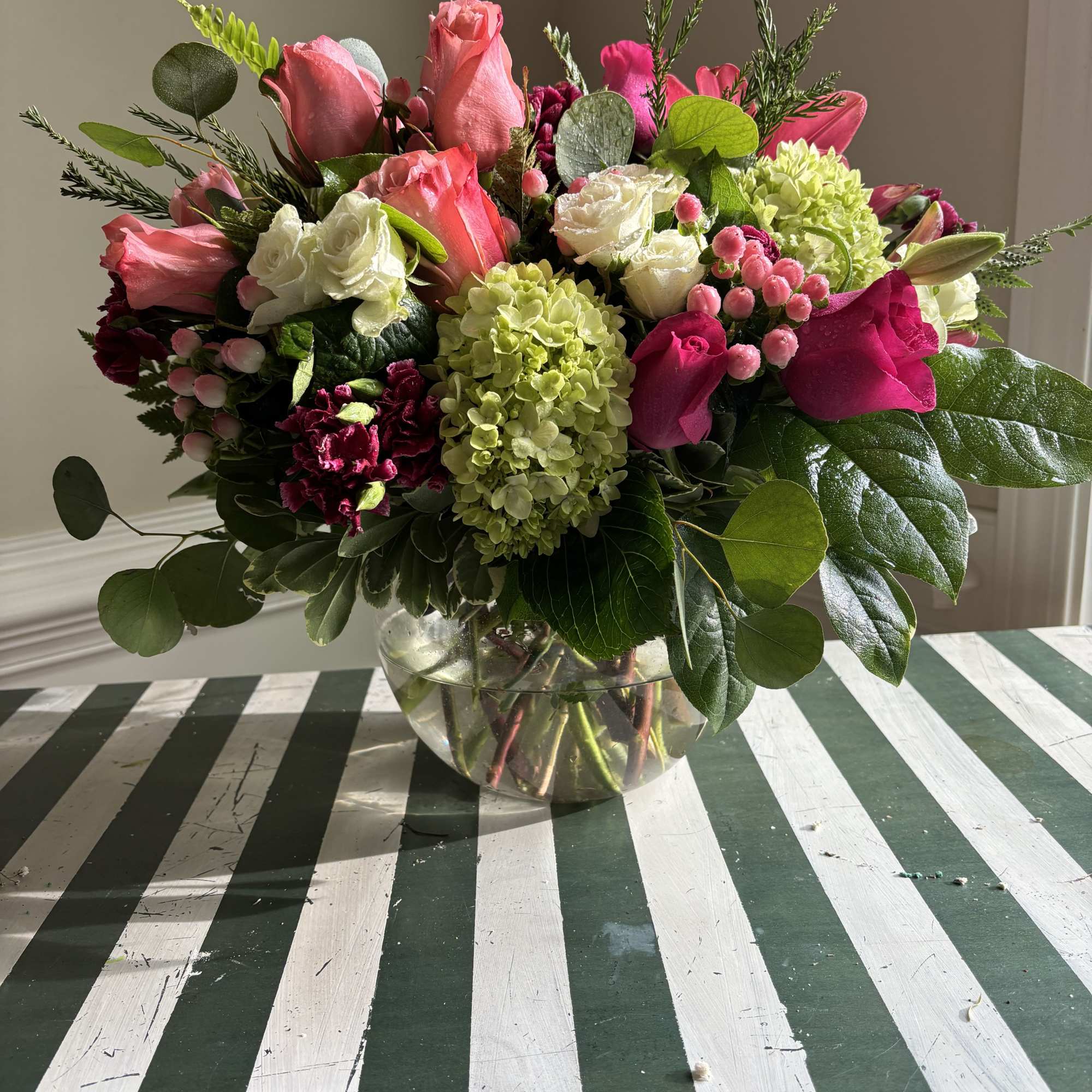Pink and white rose bouquet in a clear glass vase